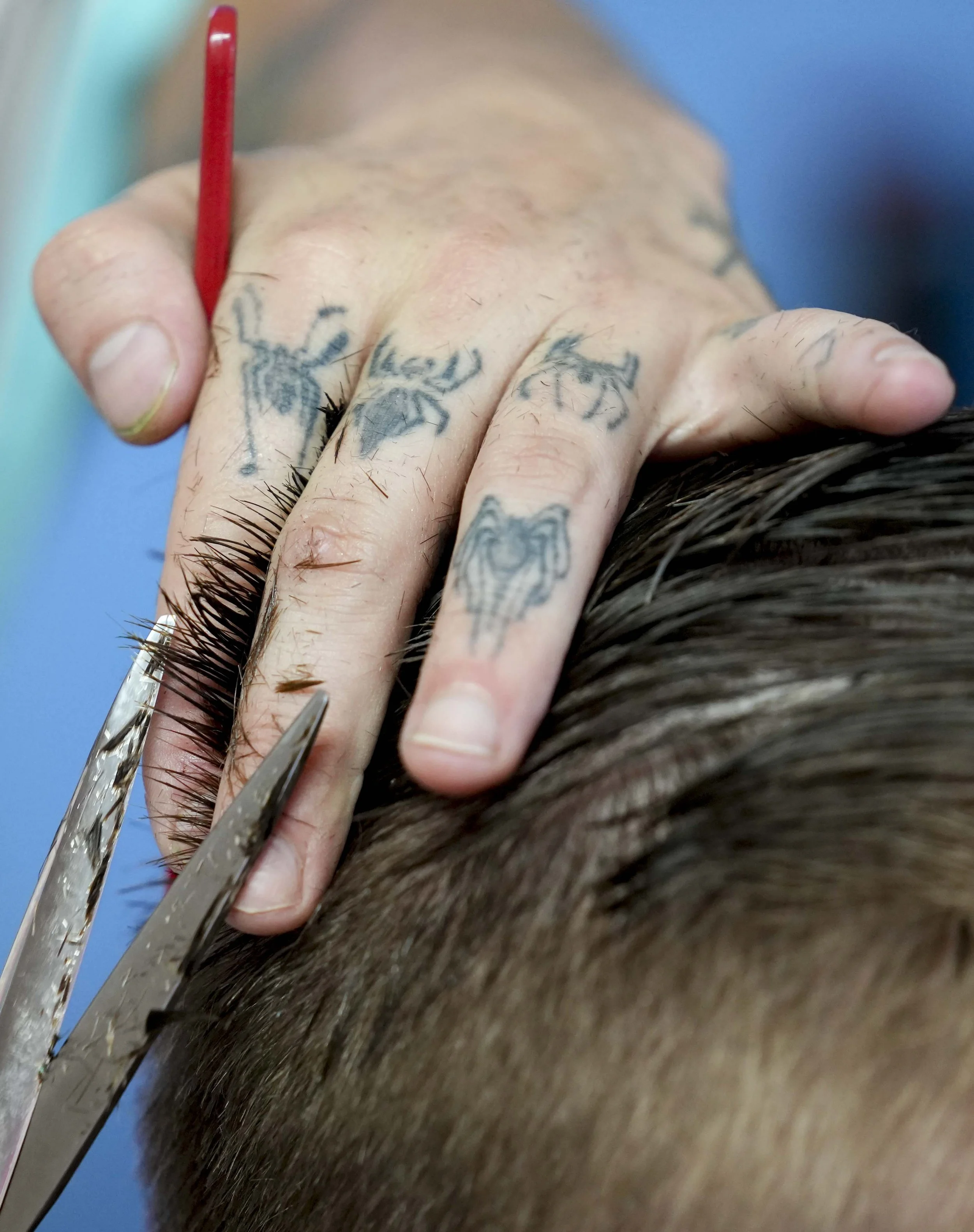  Barber Myles Parker (left) cuts Kayden McAreavy’s hair at Parker’s barbershop, named Webhead's Barbershop, on Friday, July 11, 2025, in Fountain Square.  