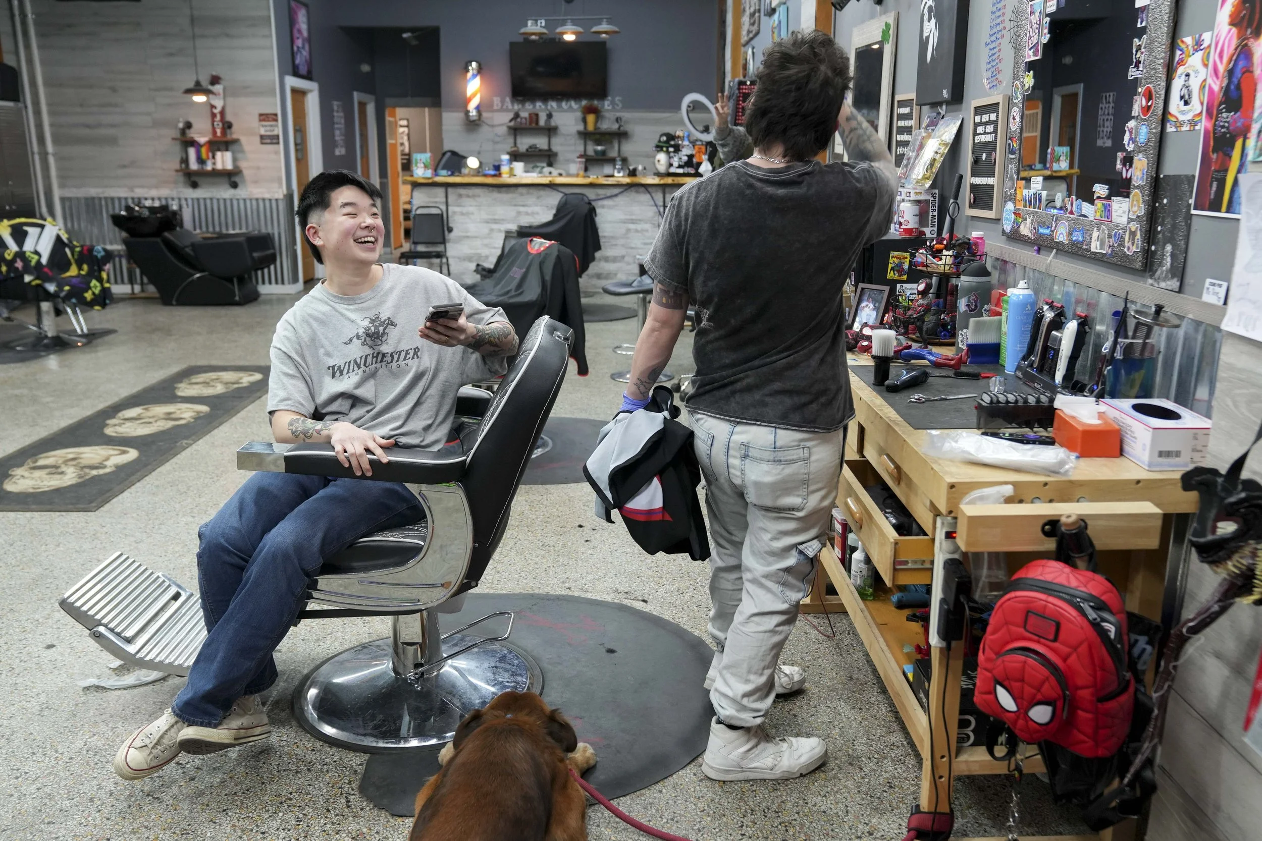  Barber Myles Parker (right) jokes with client Cristal Chan after he finishes cutting Chan’s hair on Tuesday, Feb. 4, 2025, at Bareknuckles Barbershop in Irvington. “Myles makes me feel like I belong,” Chan said. 