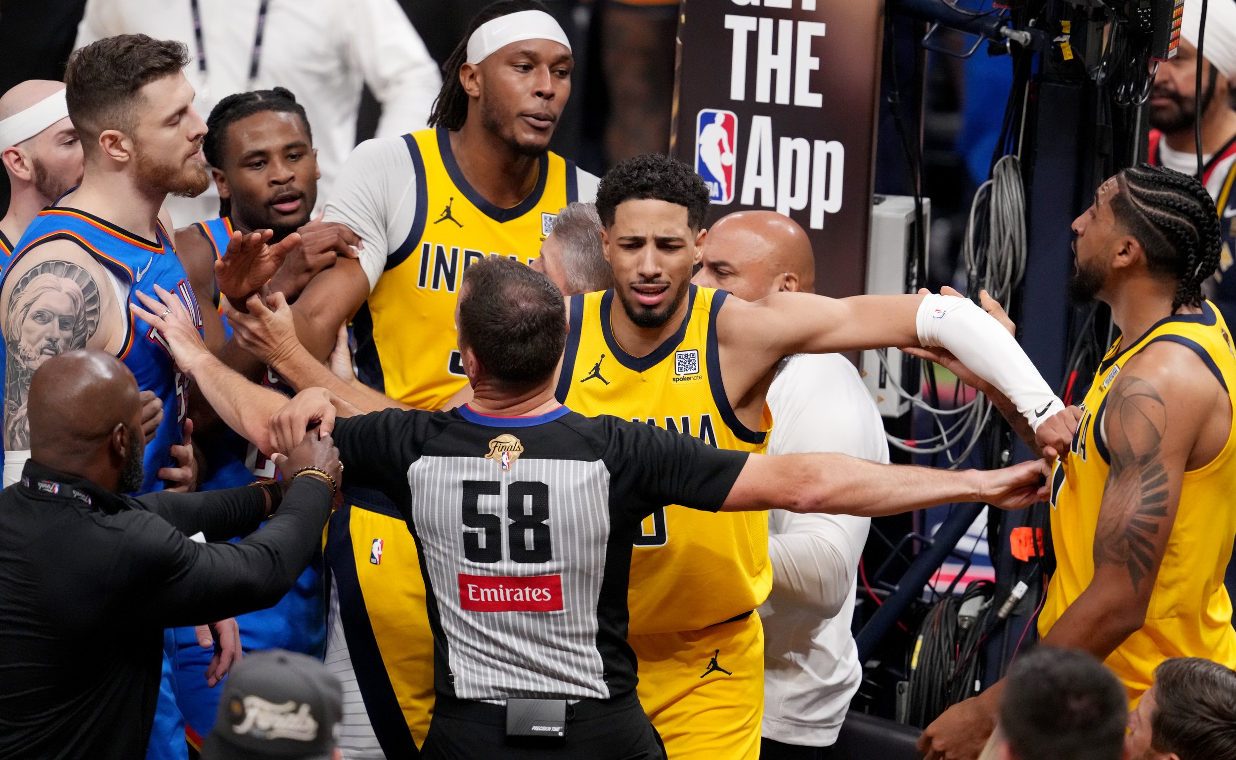  Indiana Pacers guard Tyrese Haliburton (0) holds back Oklahoma City Thunder center Isaiah Hartenstein (55) and Pacers forward Obi Toppin (1) during a scuffle Friday, June 13, 2025, during Game 4 of the NBA Finals at Gainbridge Fieldhouse in Indianap