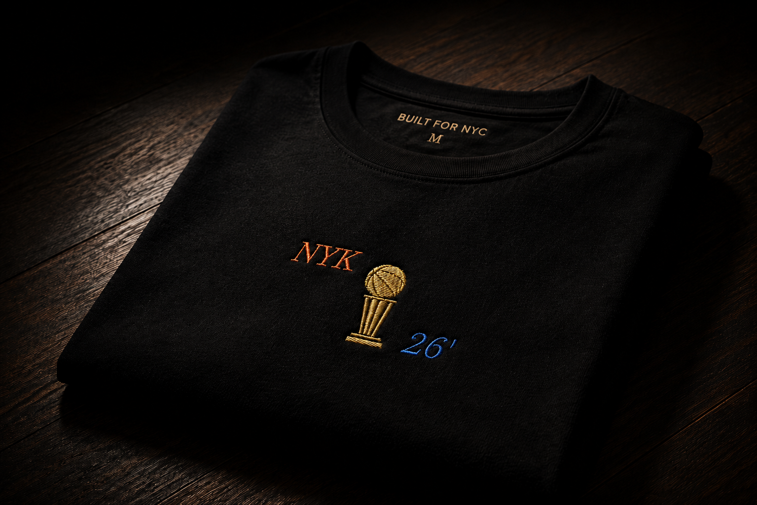 Knicks+Embroidered+NYK+FINALS+Trophy+'+26+Men's+Premium+Short+Sleeve+Tee+Folded.webp