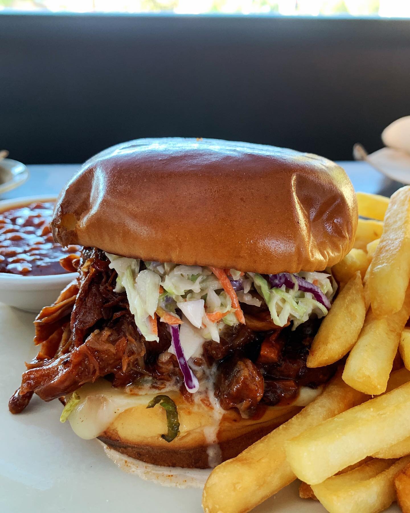 Loaded Pulled Pork: slowly simmered pork in our signature BBQ sauce with pickles, melted Jack cheese, roasted jalape&ntilde;os and creamy coleslaw on a toasted brioche bun. 🔥 #NewSpecial