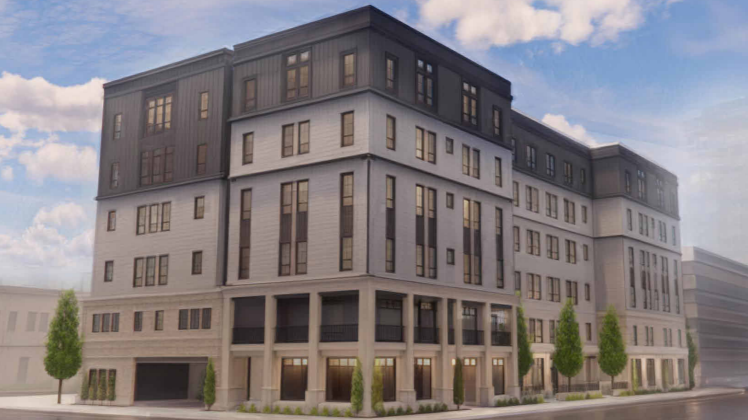 Modern multi-story residential building with large windows and trees on a city street