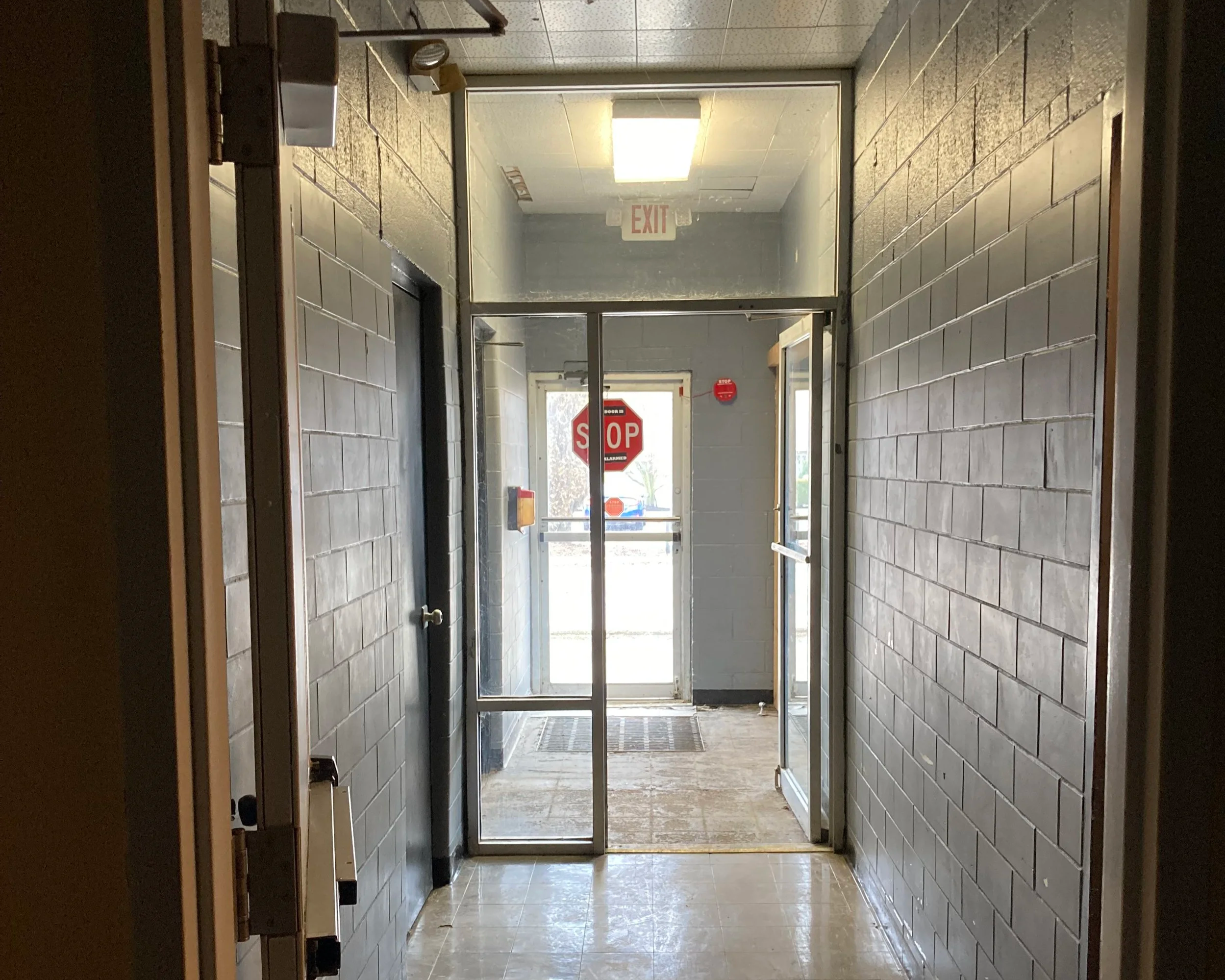 empty corridor in an aging school building evaluated for renovation or adaptive reuse.