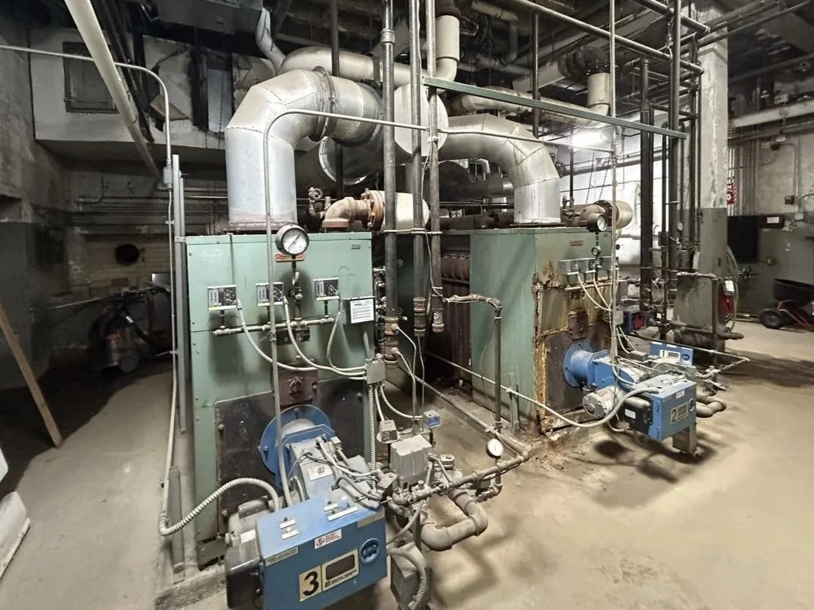 Aging boiler and mechanical systems evaluated during an apartment conversion feasibility assessment.
