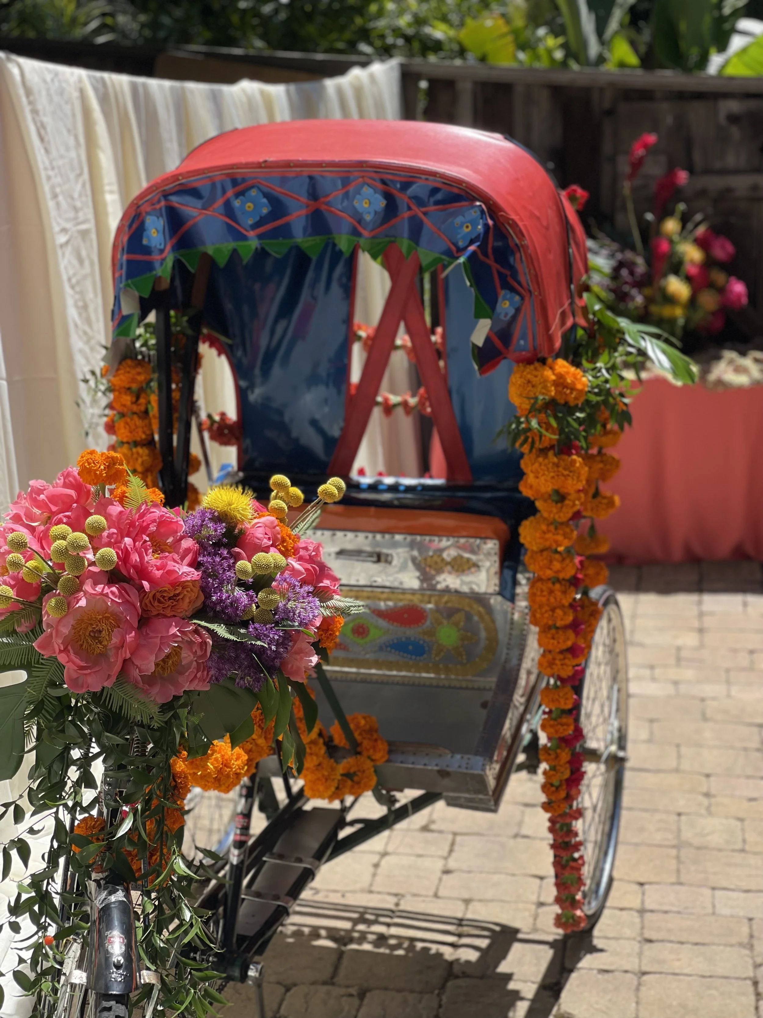 Vibrant Indian rehearsal dinner floral design
Mehndi party event décor inspiration
Luxury Indian wedding pre-event styling
Colorful marigold floral installation
South Asian wedding floral designer
Bright pink and orange wedding flowers
Whimsical Indi