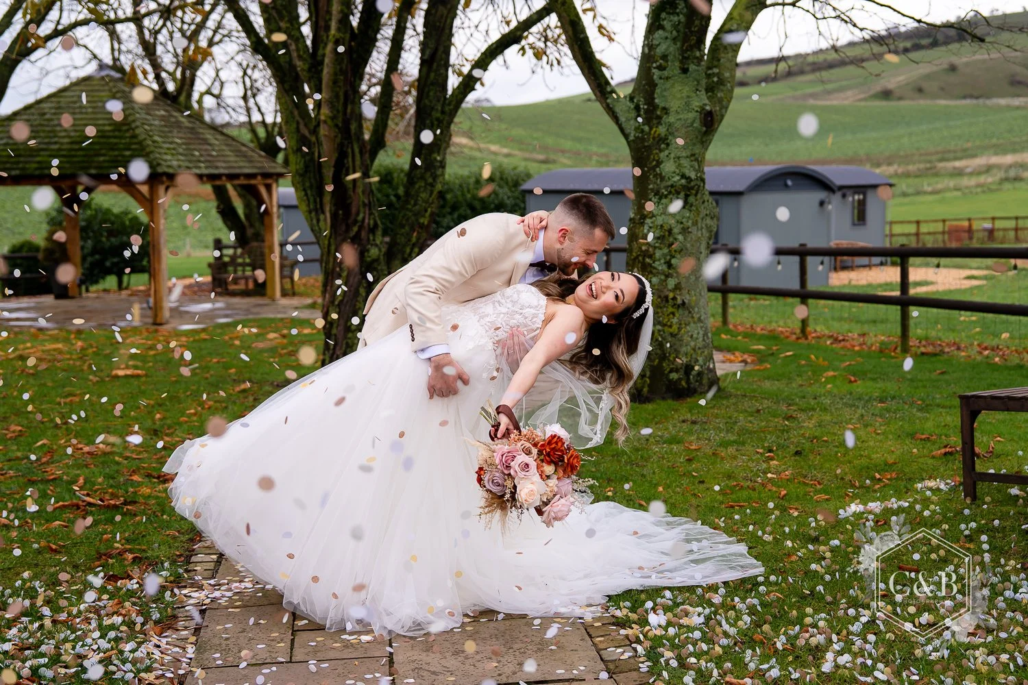 A Bride and Groom are showered in confetti at Wellington Barn