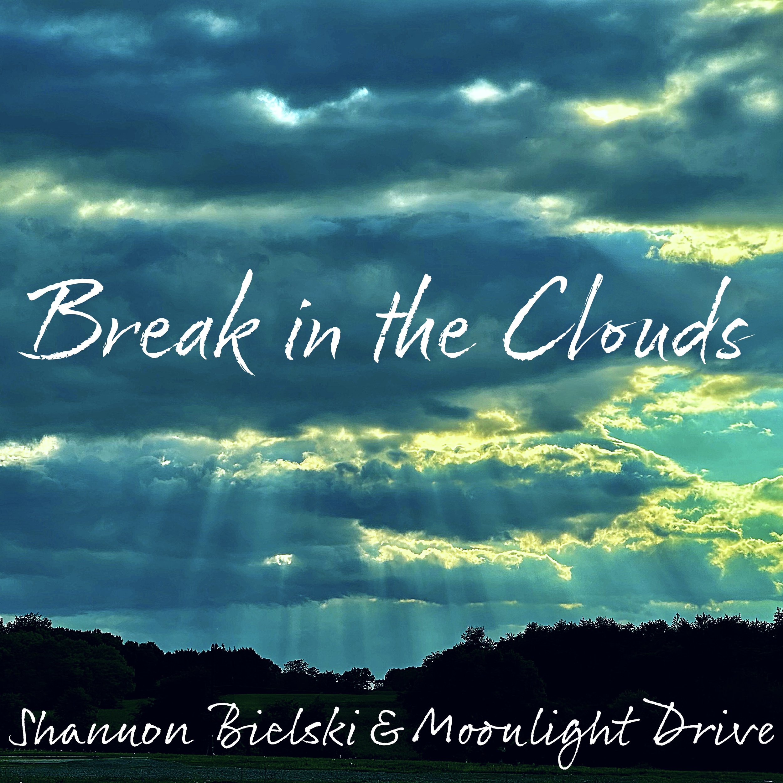 A cloudy sky with sunlight breaking through, with trees and a field below, overlaid with the text 'Break in the Clouds' and the names 'Shannon Bielski & Moonlight Drive'.