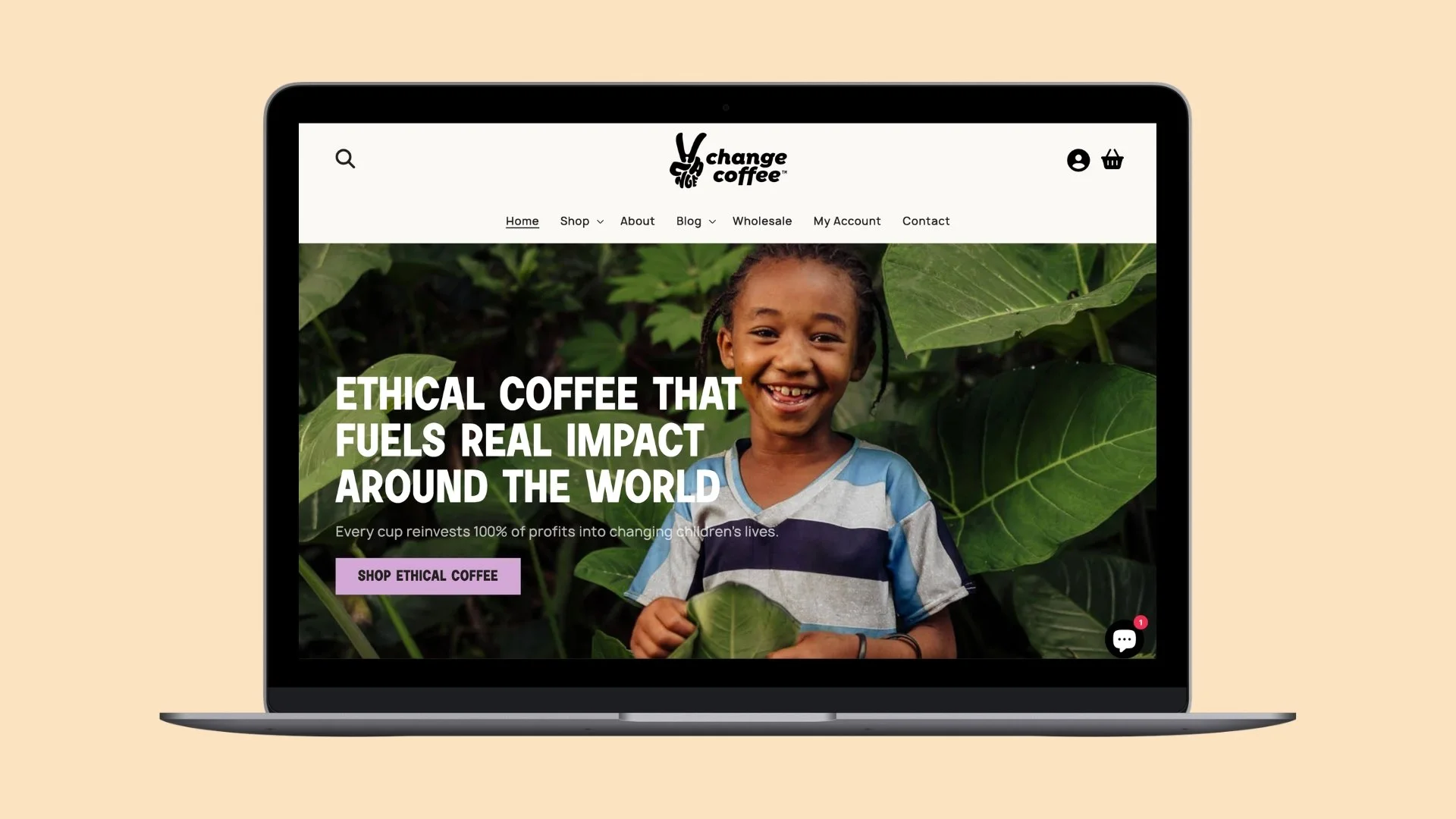 Laptop displaying a website for Change Coffee with a large image of a hand holding a coffee bag against a blue sky background.