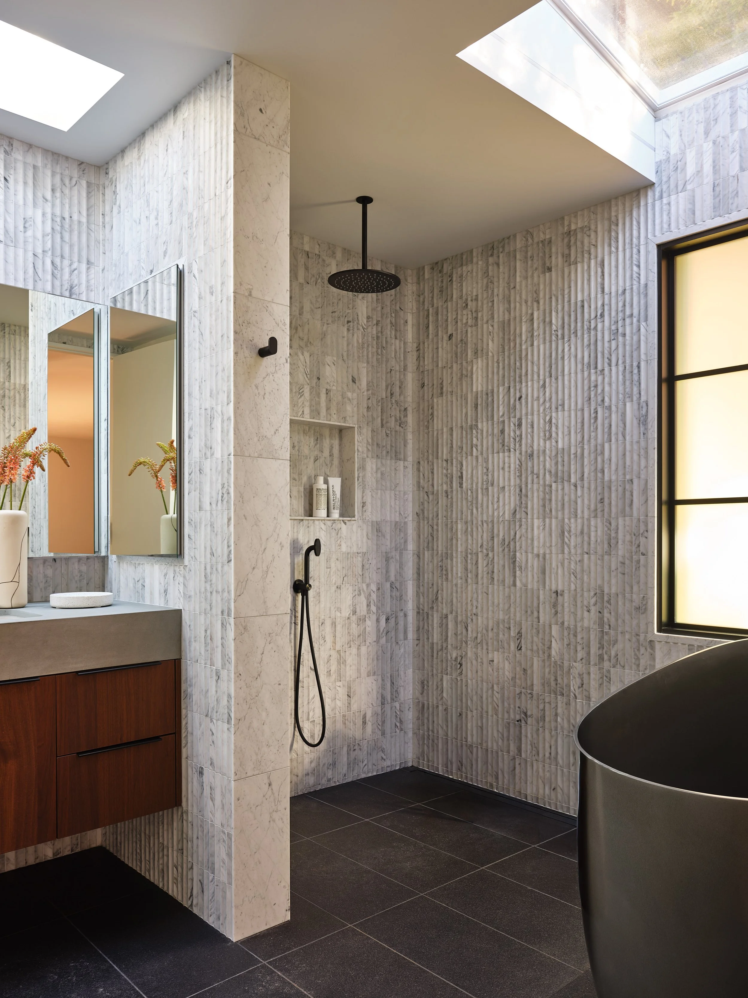 Contemporary primary bathroom with custom architectural details