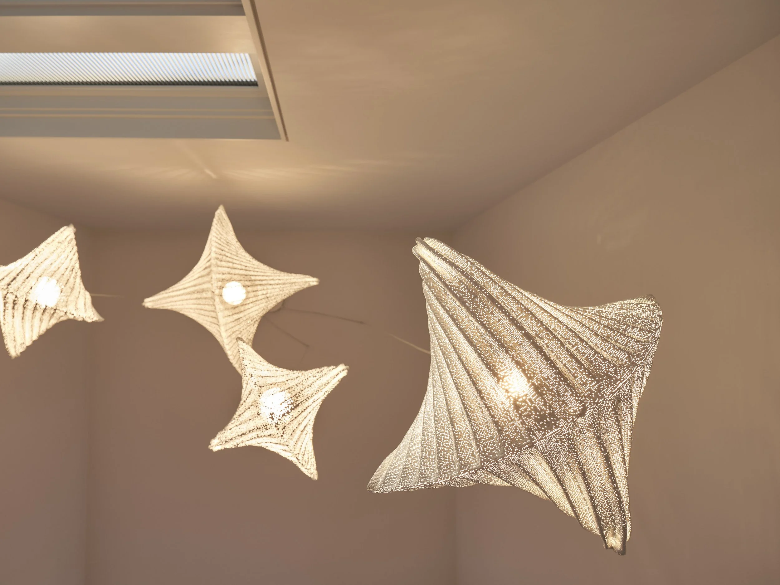 Sculptural lighting detail at warm modern Lakeshore Residence in Oakland