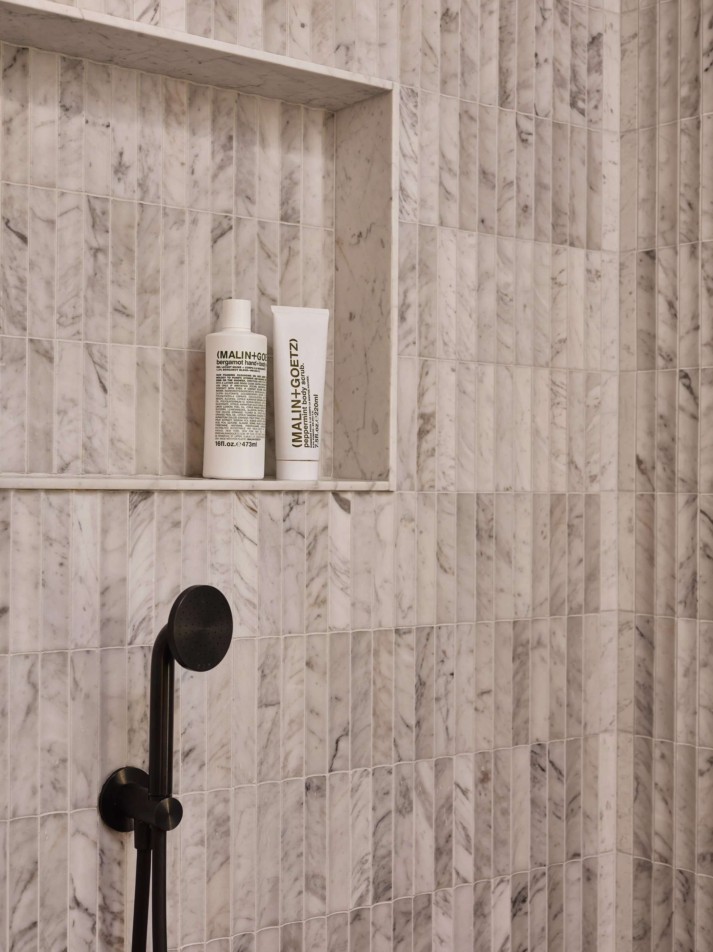 Custom tiled shower niche in the primary bathroom