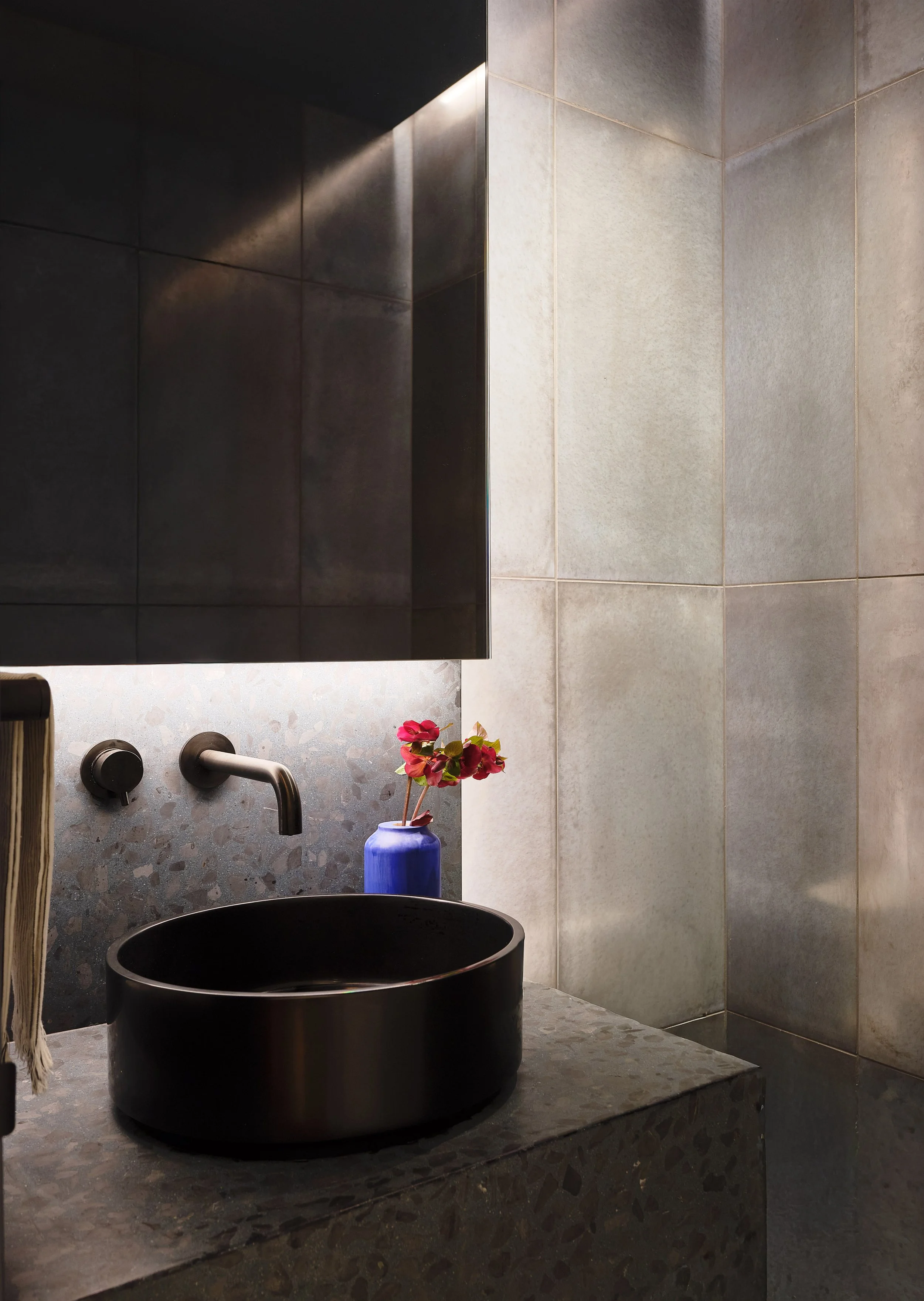 Custom lighting and stone details in the powder room