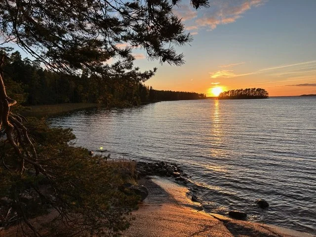 Kaunis kesäinen auringonlasku rannalta nähtynä