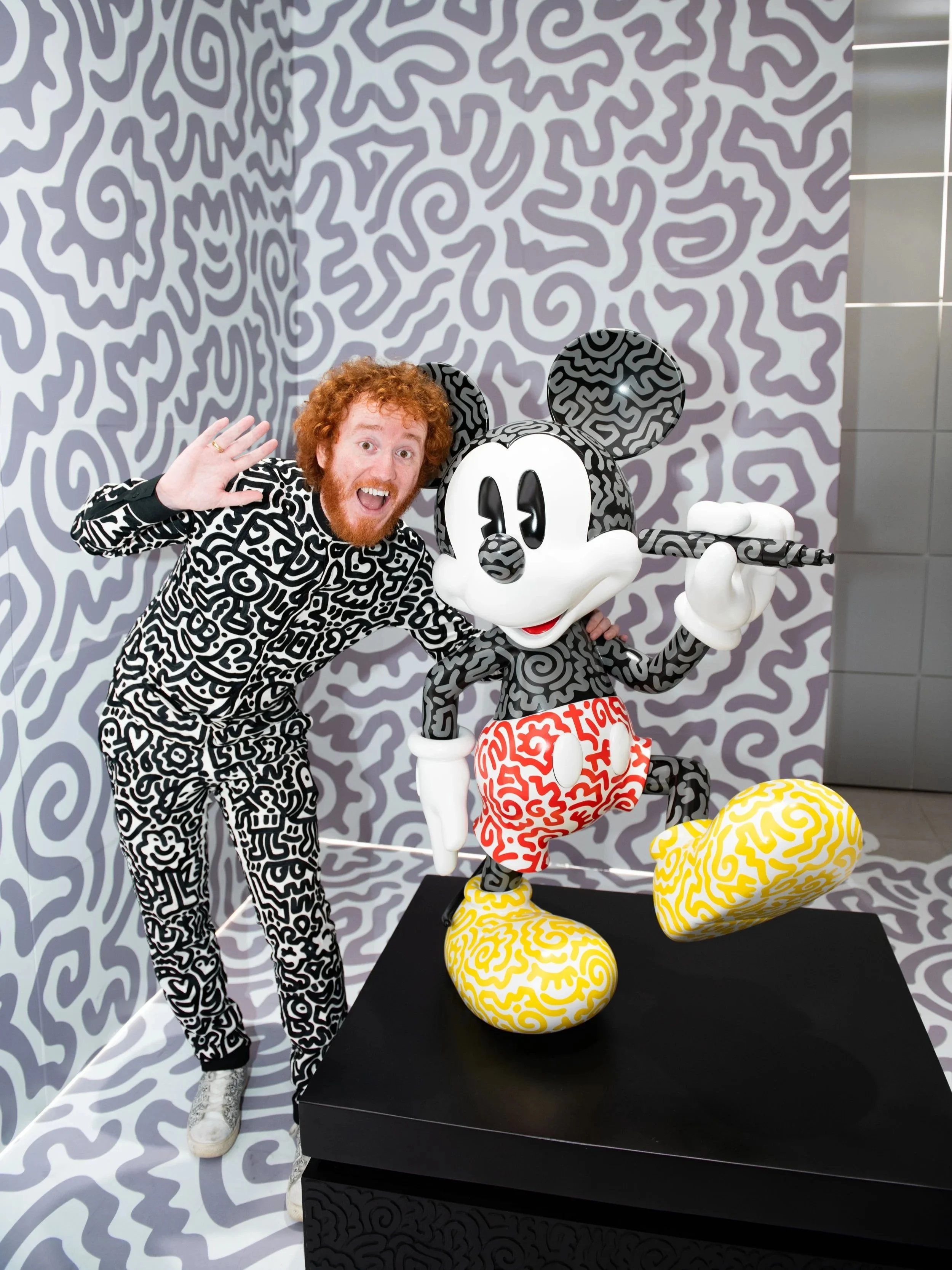 Mr Doodle posing with an iconic character sculpture, blending pop culture references with his distinctive style.