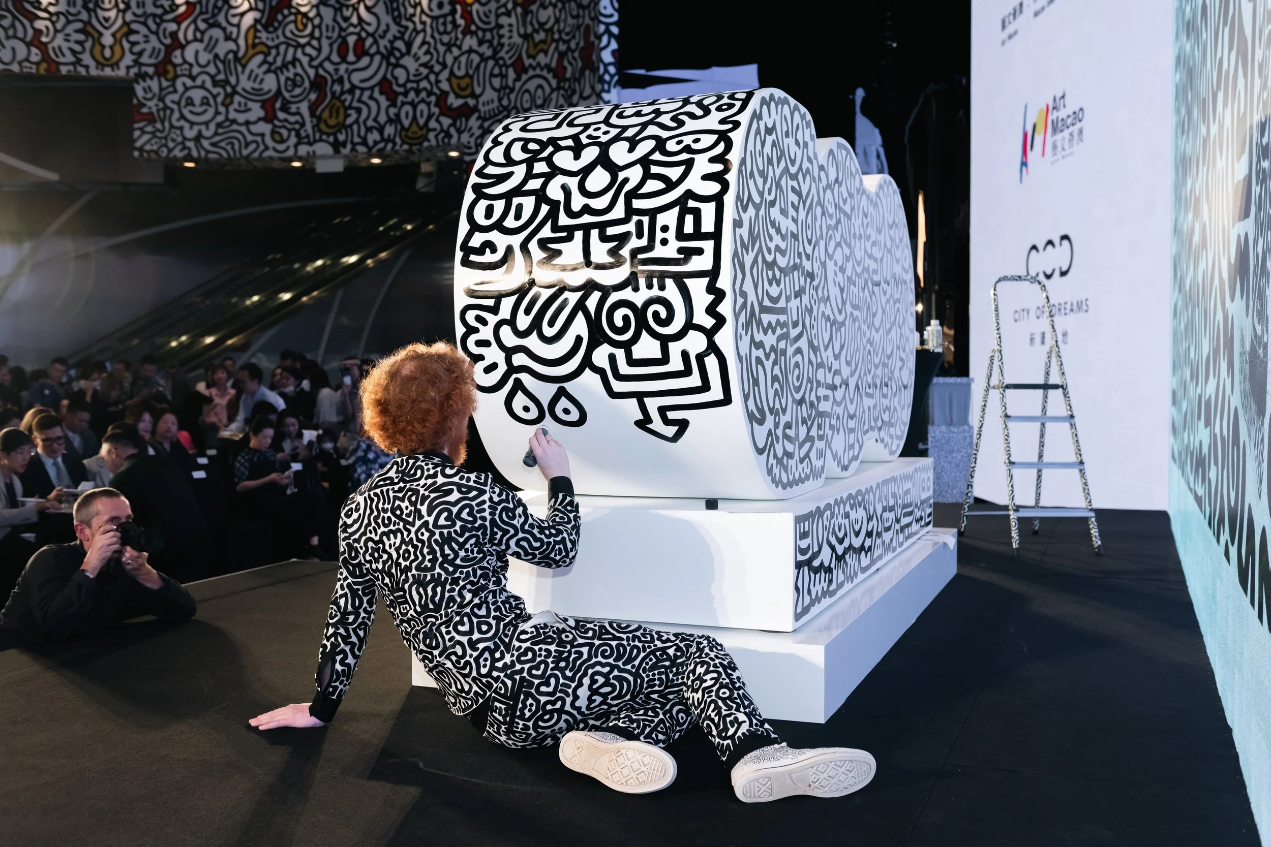 Exhibition view highlighting the integration of illustrated surfaces across walls and floors.