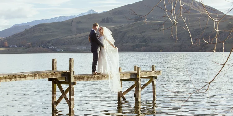An intimate Southern Lakes elopement beside an alpine lake, photographed by Fiona Tomlinson.