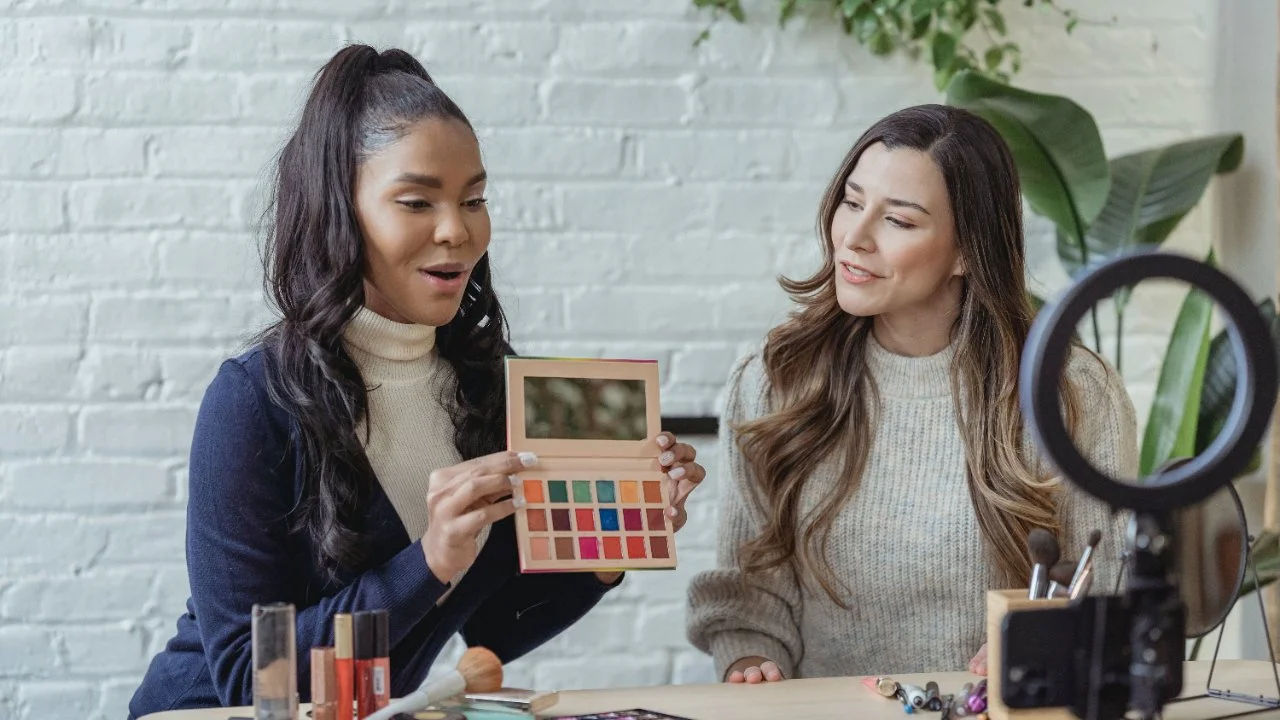 two estheticians showing off makeup