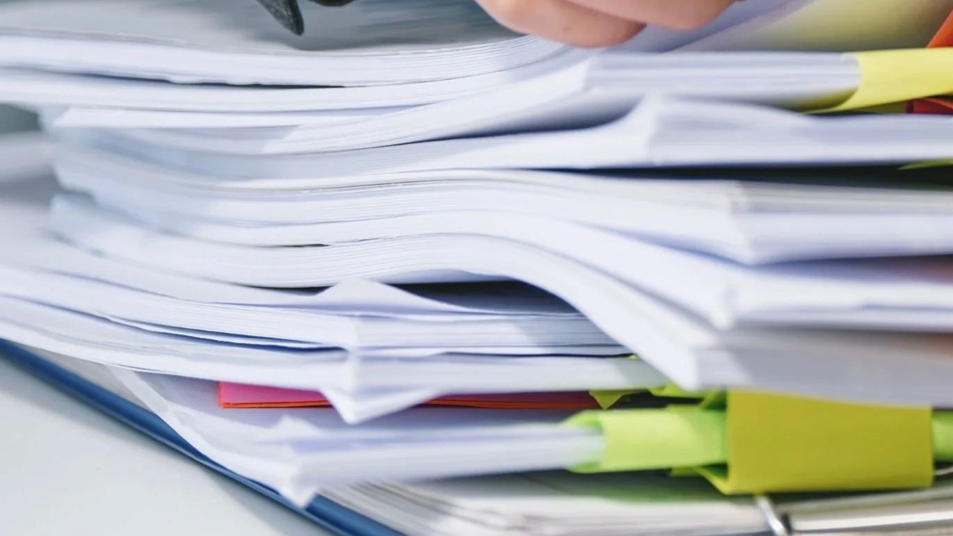 Accreditation surveyor examines personnel files for key documents  