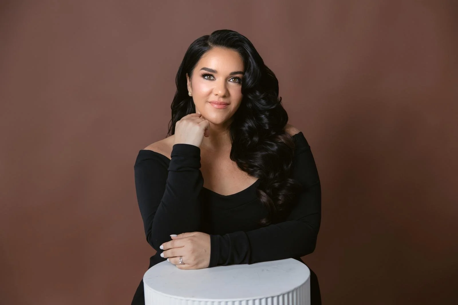Studio portrait of soprano Jeanette Vecchione-Donatti on a warm brown background