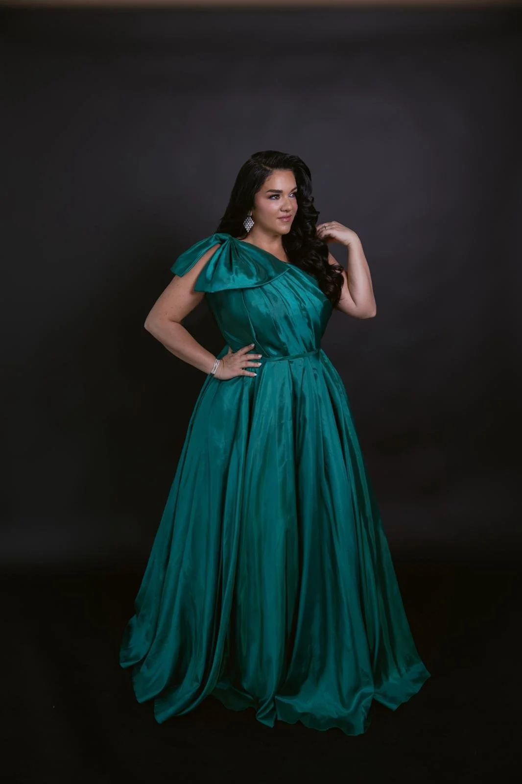 Jeanette Vecchione-Donatti in an emerald one-shoulder gown with bow detail