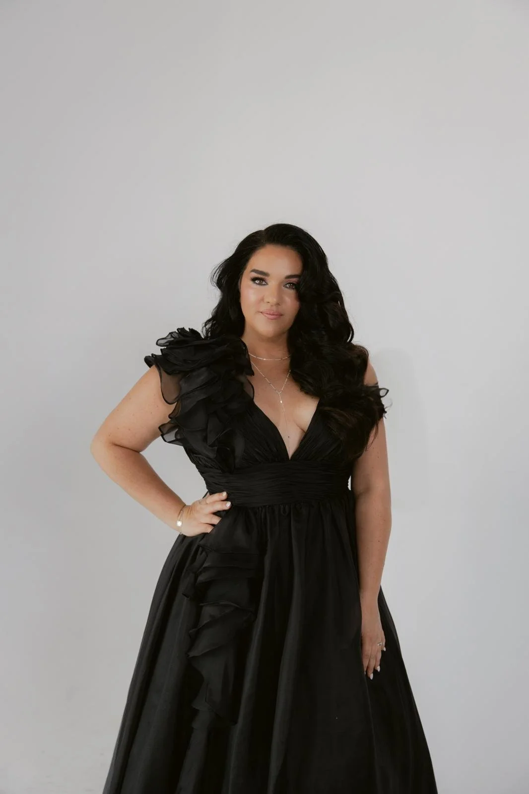 Jeanette Vecchione-Donatti in a black ruffled gown, studio portrait