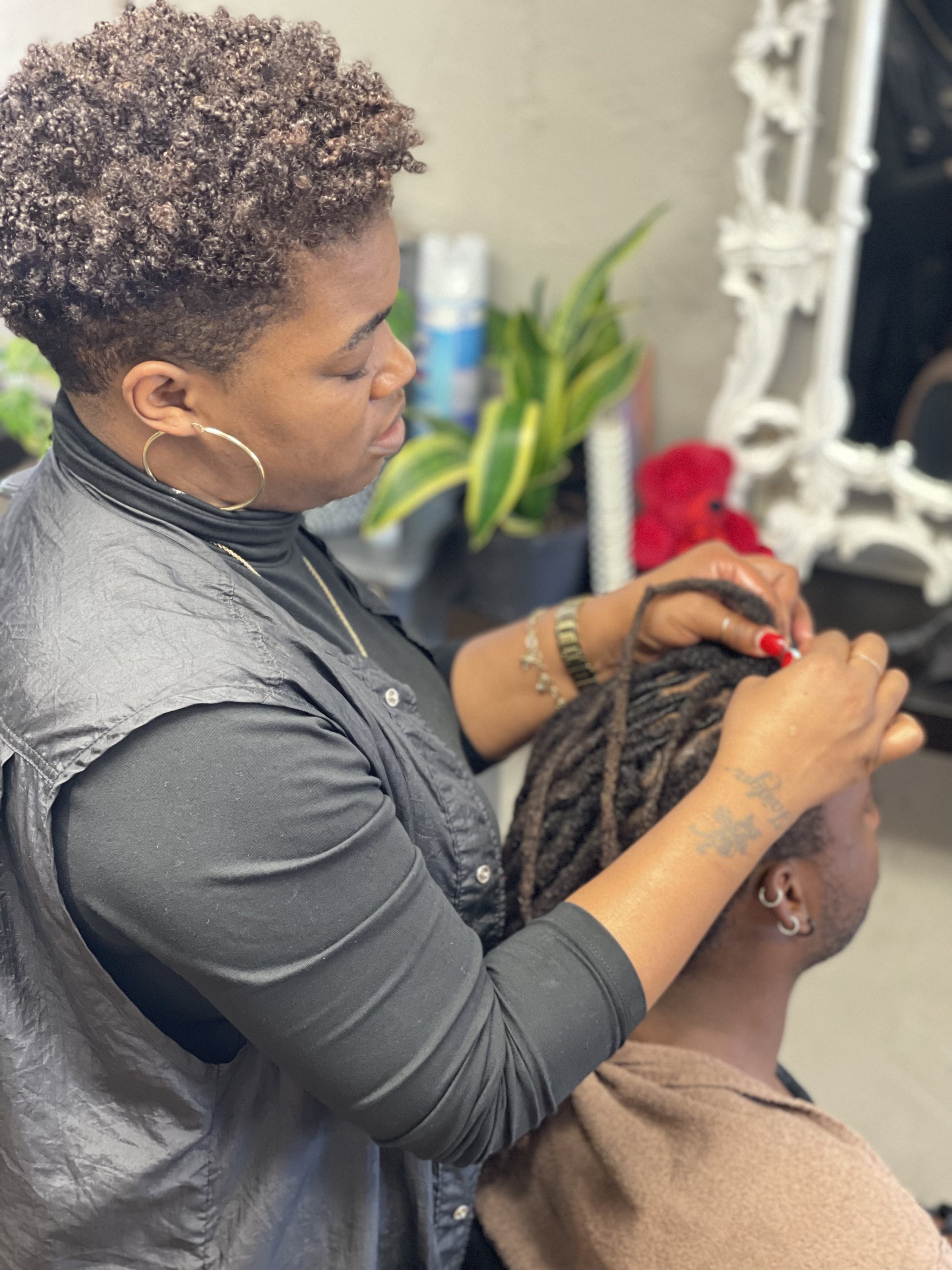 Chanel Arline maintaining a client's locs at her Baytown TX salon