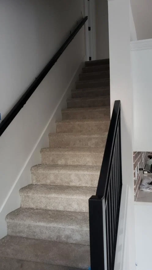Stairway custom black steel handrail