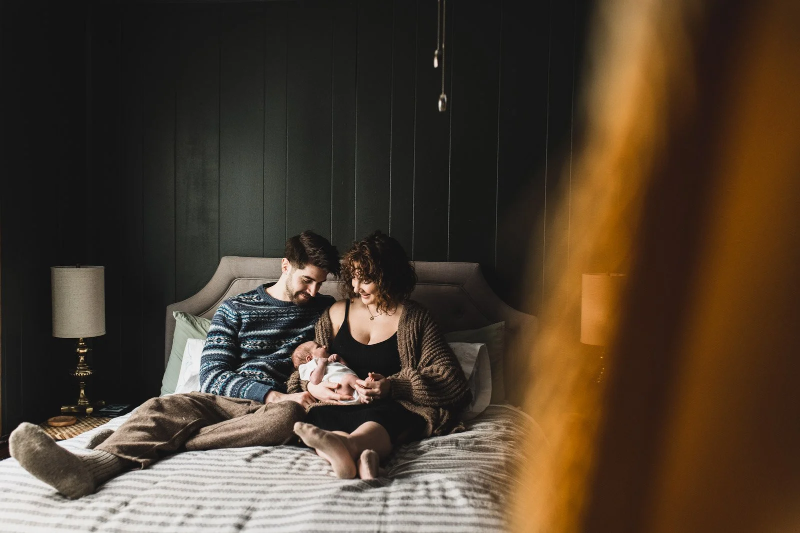 new family of 3 on bed