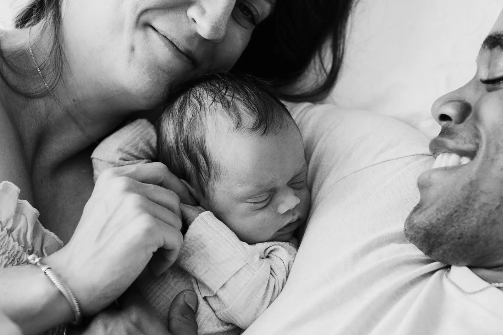mom and dad with new baby close up