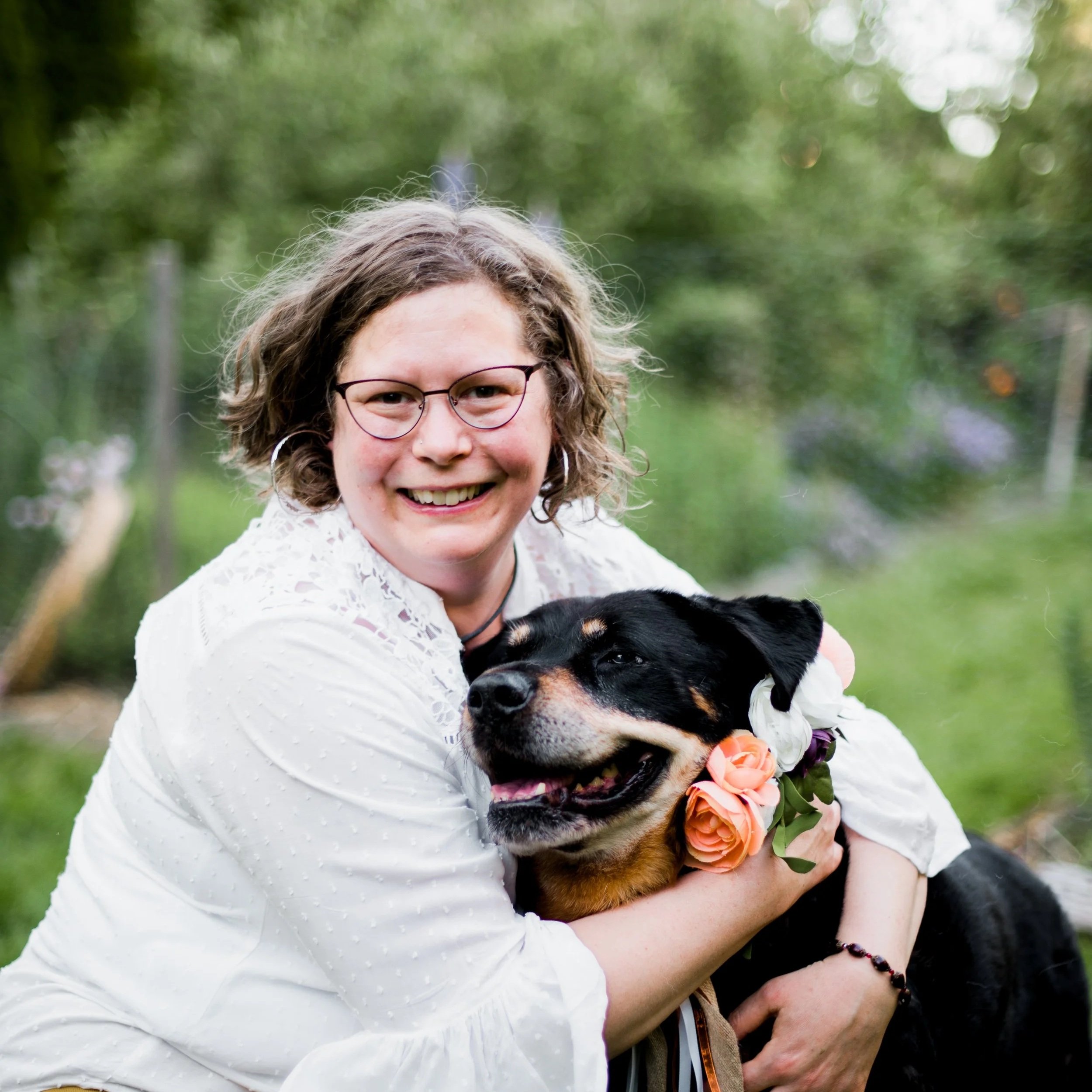 Bellingham Animal Communicator, Joanna Schmidt in the garden with her dog, Raspberry