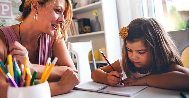 girl and woman working together on writing