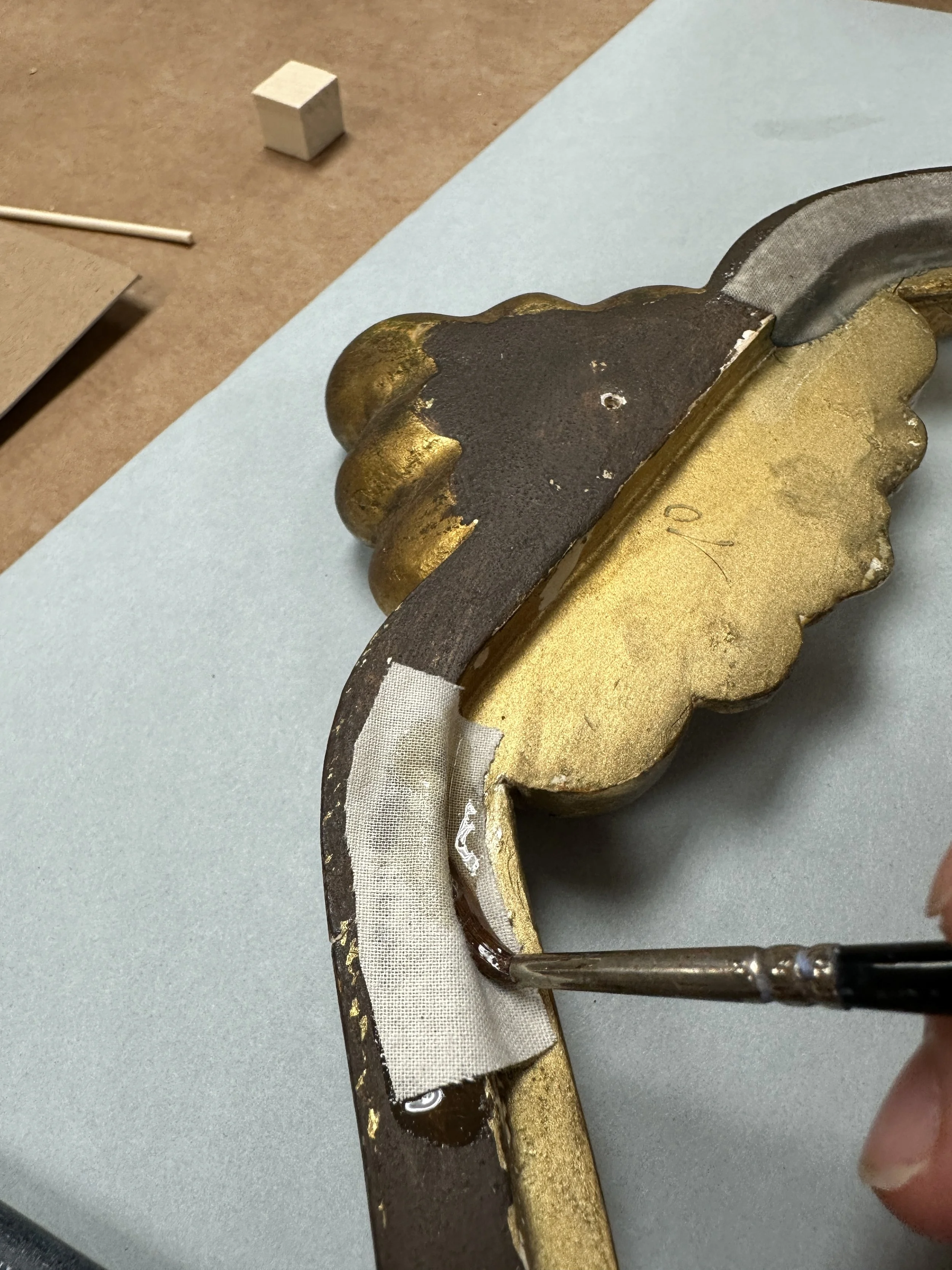 Saturating the cotton muslin strip with excess hide glue. (Photo: Jennifer Kim)