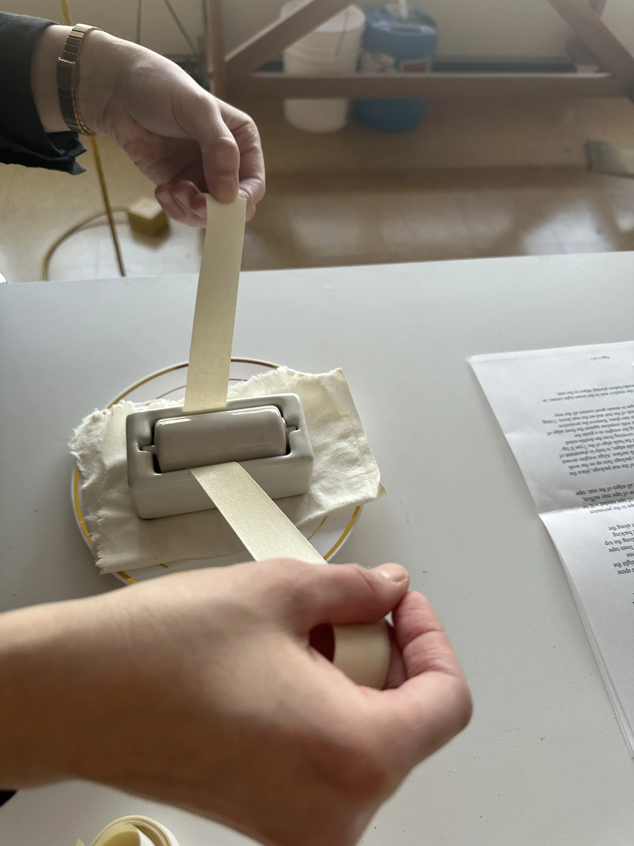 Carla preparing the linen adhesive tape for the spine of the mat. (Photo: Jennifer Kim)