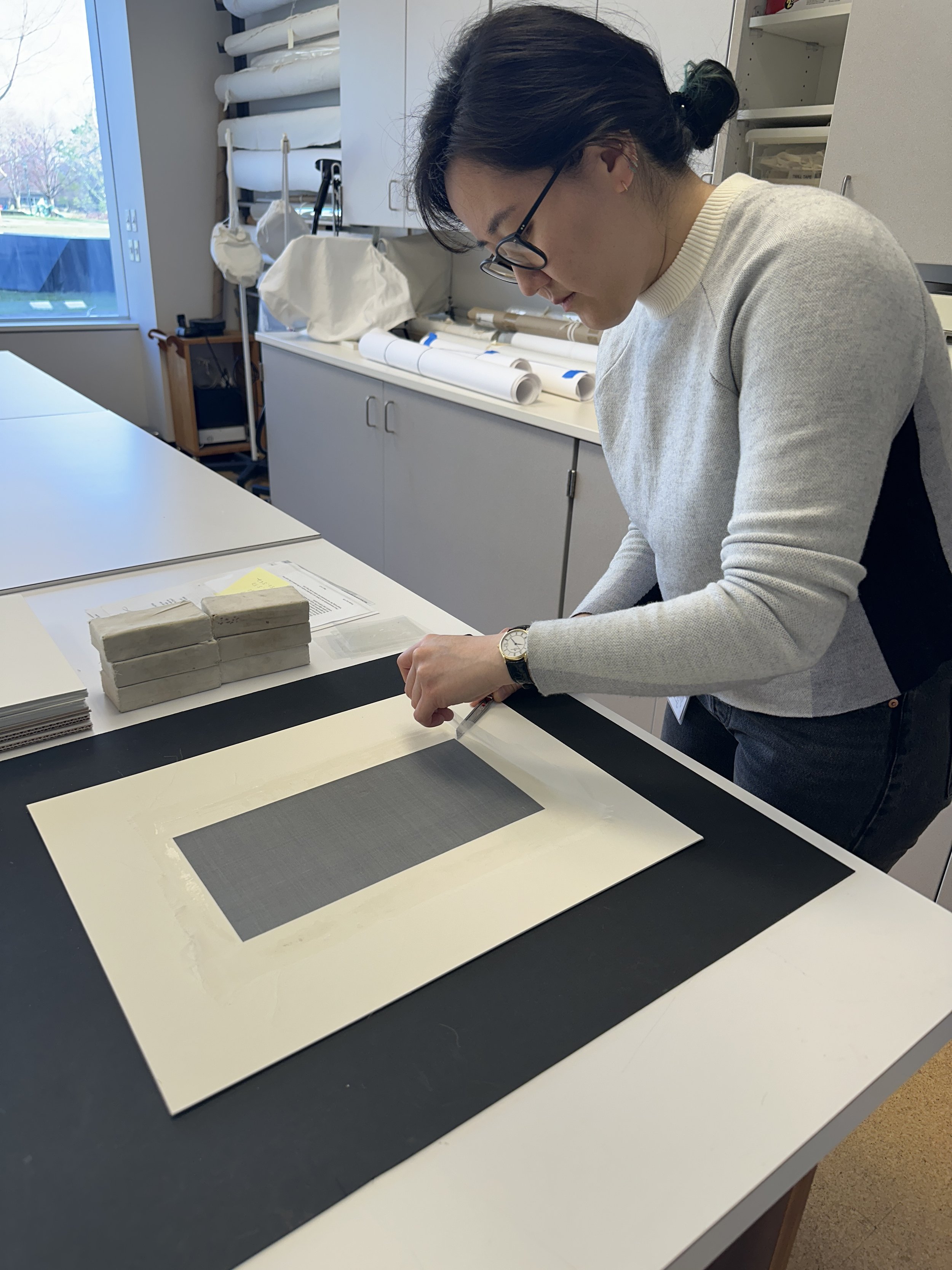 Cutting off the excess crepeline along the edges with a sharp blade. (Photo: Carla Fontecchio)