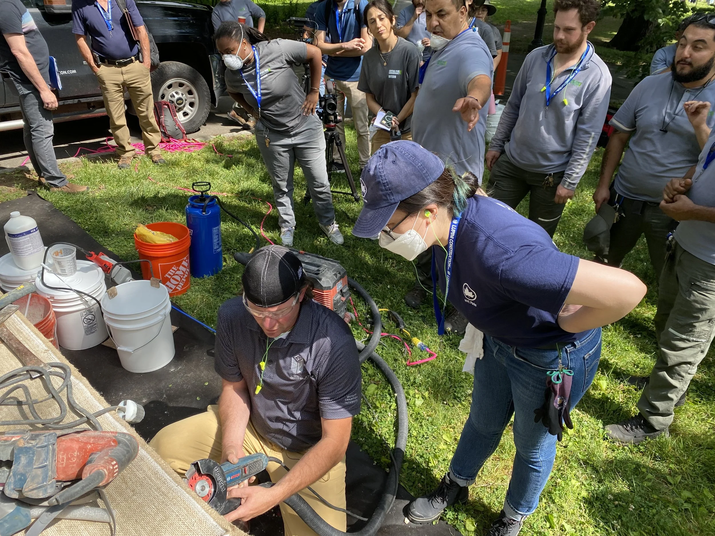 Learning various ways to removed old mortar from a mason. (Photo: NYC Parks)