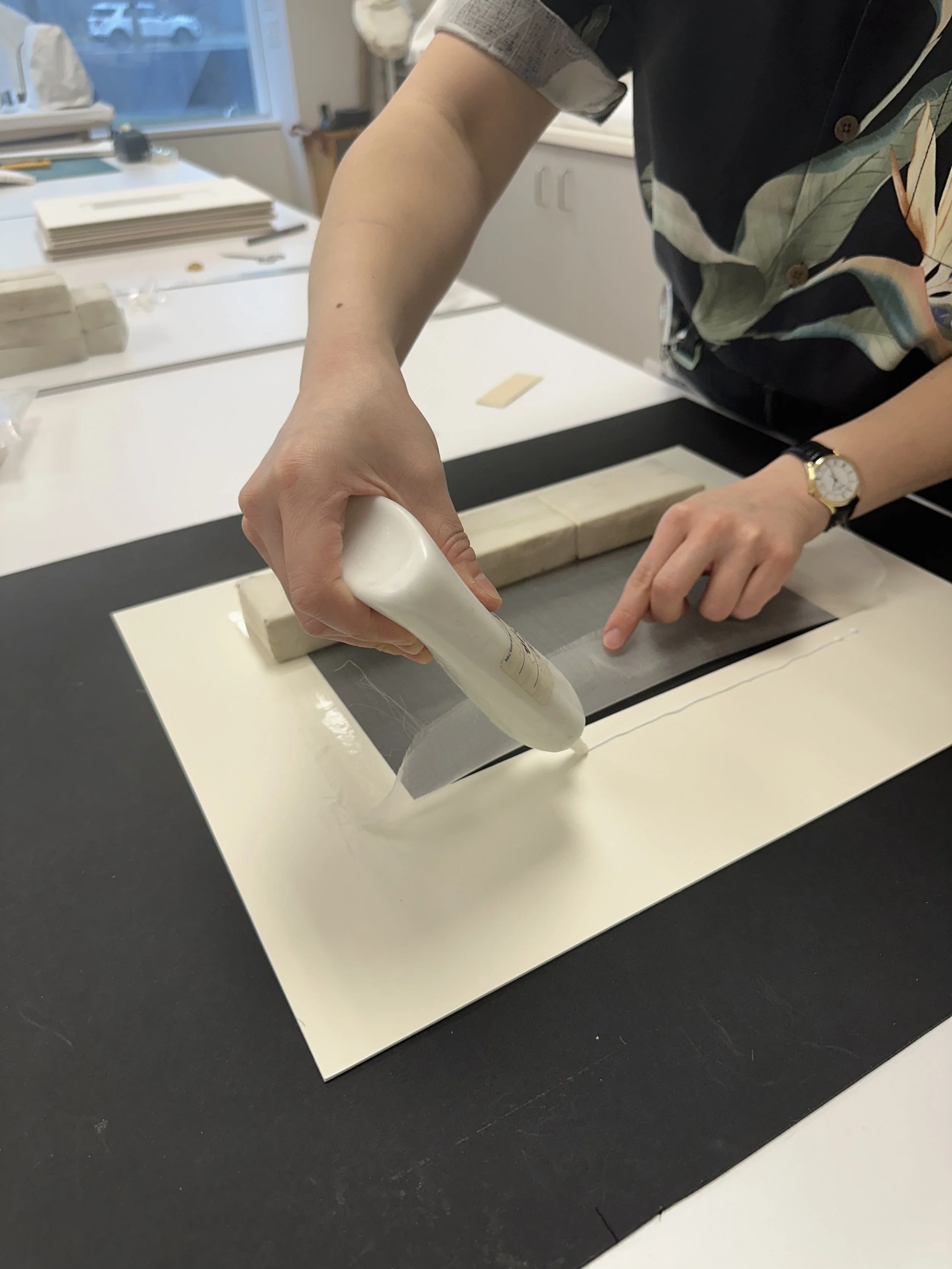 Laying down the line of PVA glue for the crepeline window. (Photo: Carla Fontecchio)