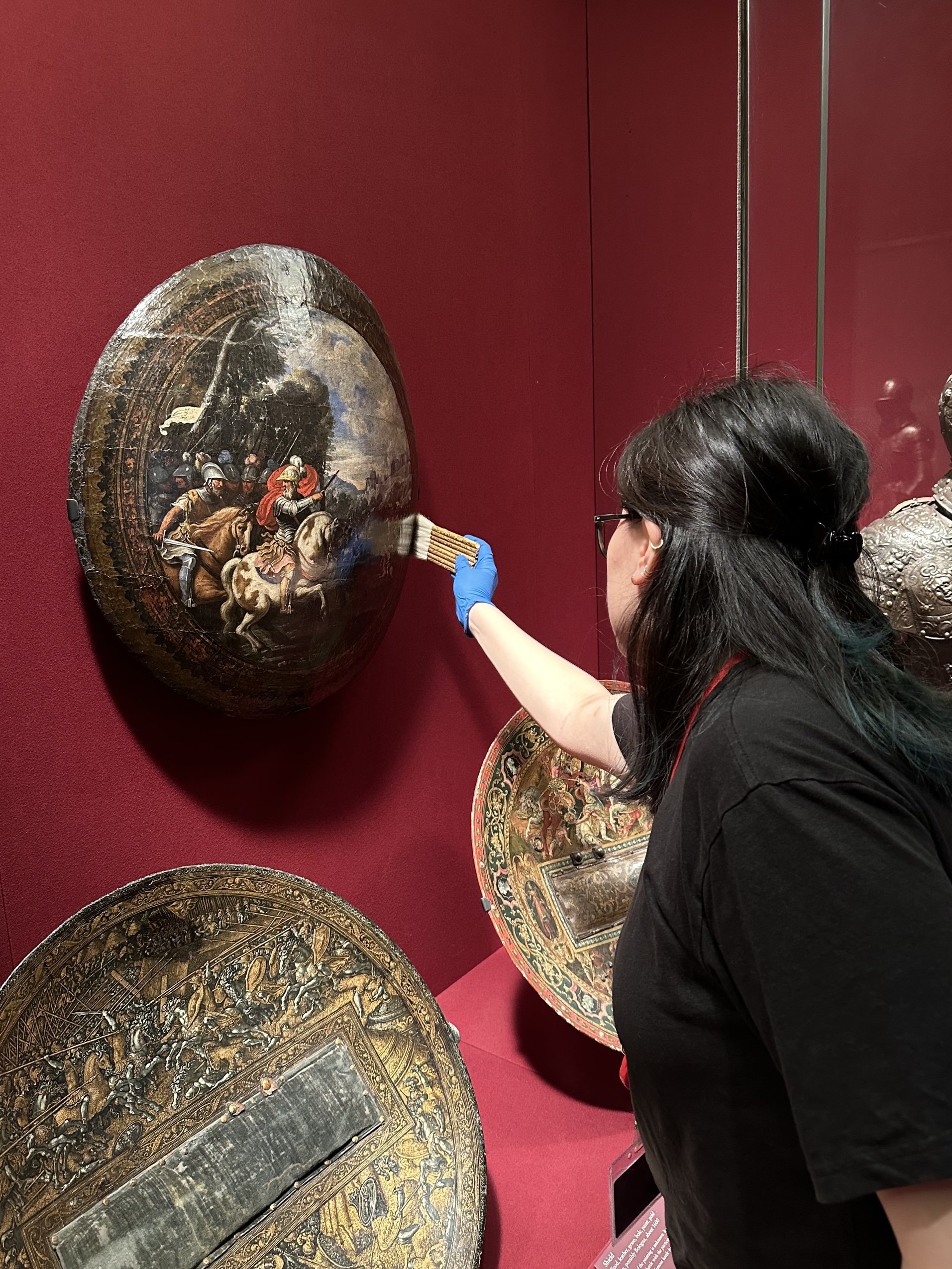 Dusting a painted shield. (Photo: Sean Belair)