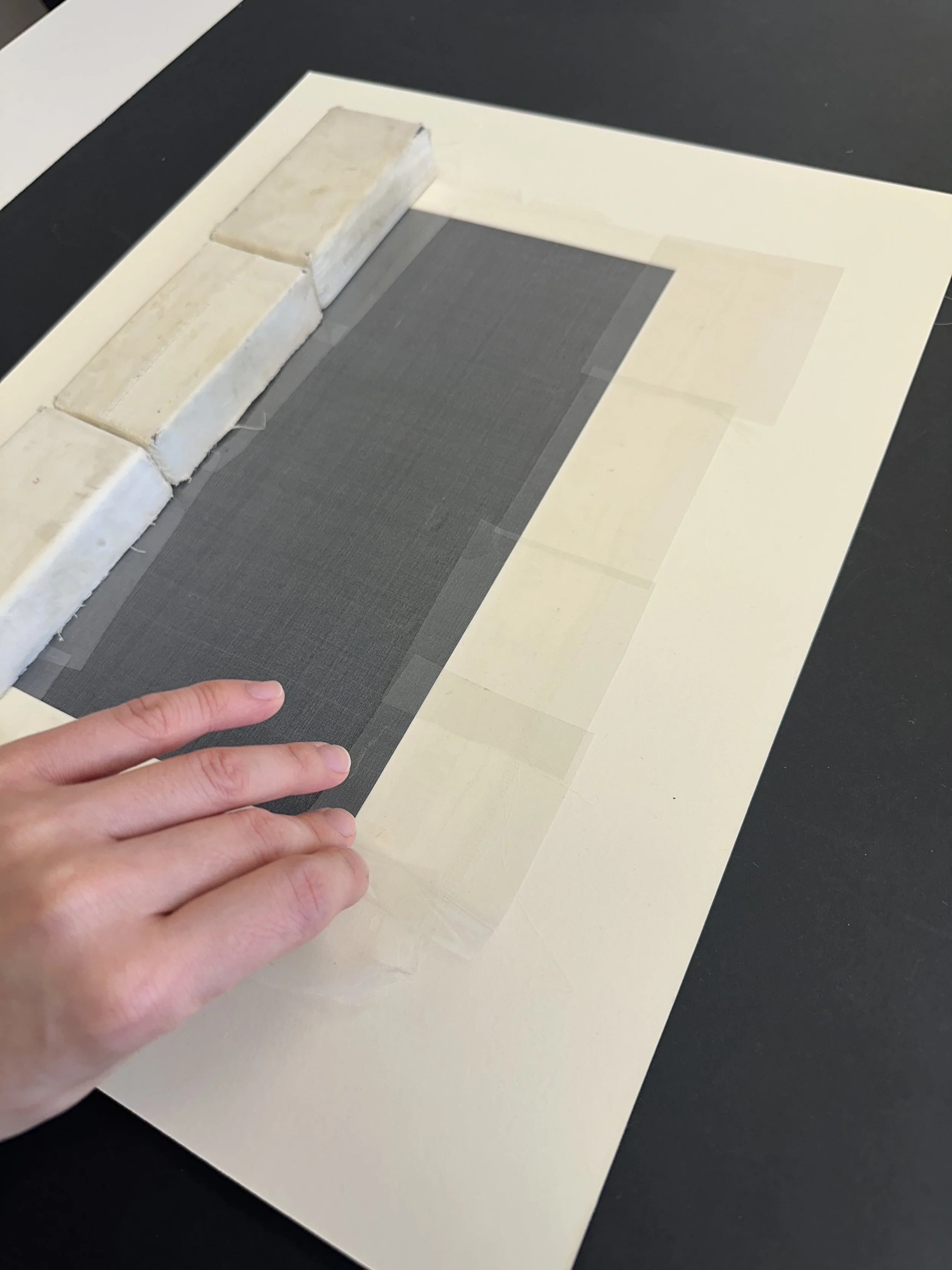 Peeling the mylar off the dried adhesive. (Photo: Jennifer Kim)