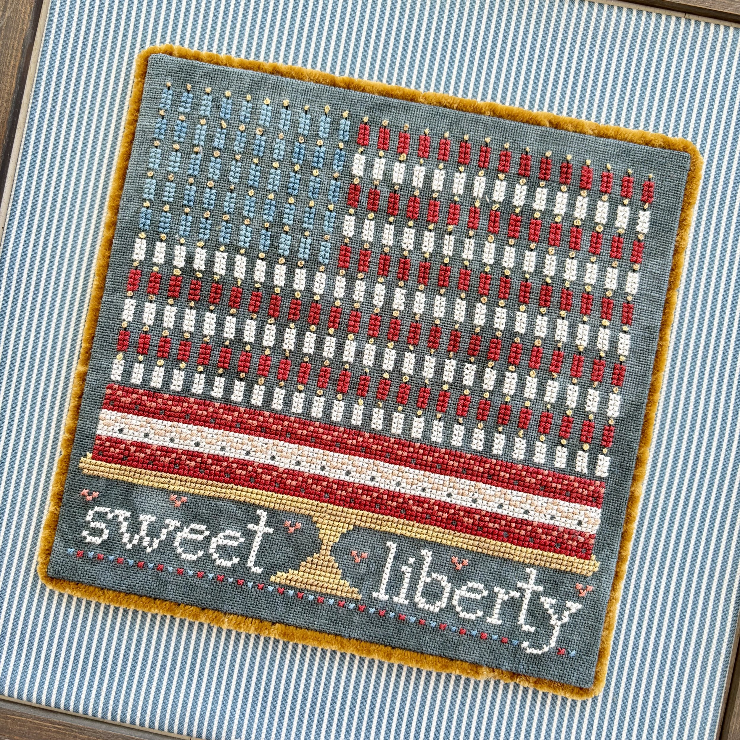 Sweet Liberty cross stitch piece with patriotic cake with 250 candles