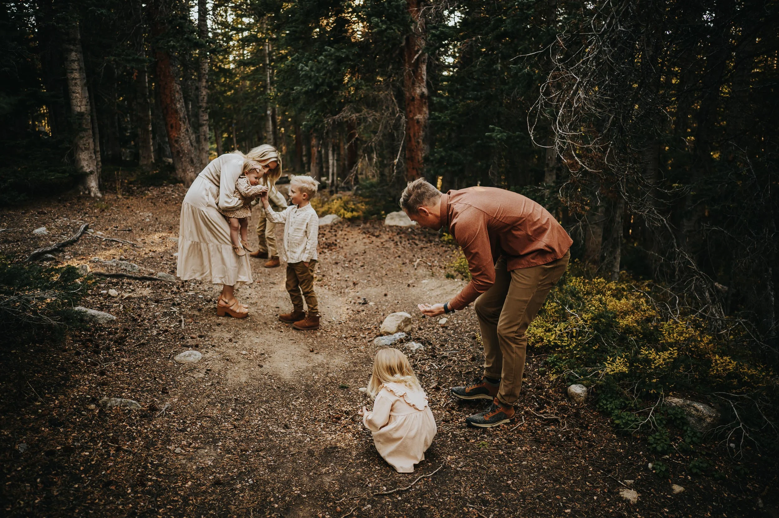 Family surrounded by warm golden light during mountain photo session at Brainard Lake in Colorado.