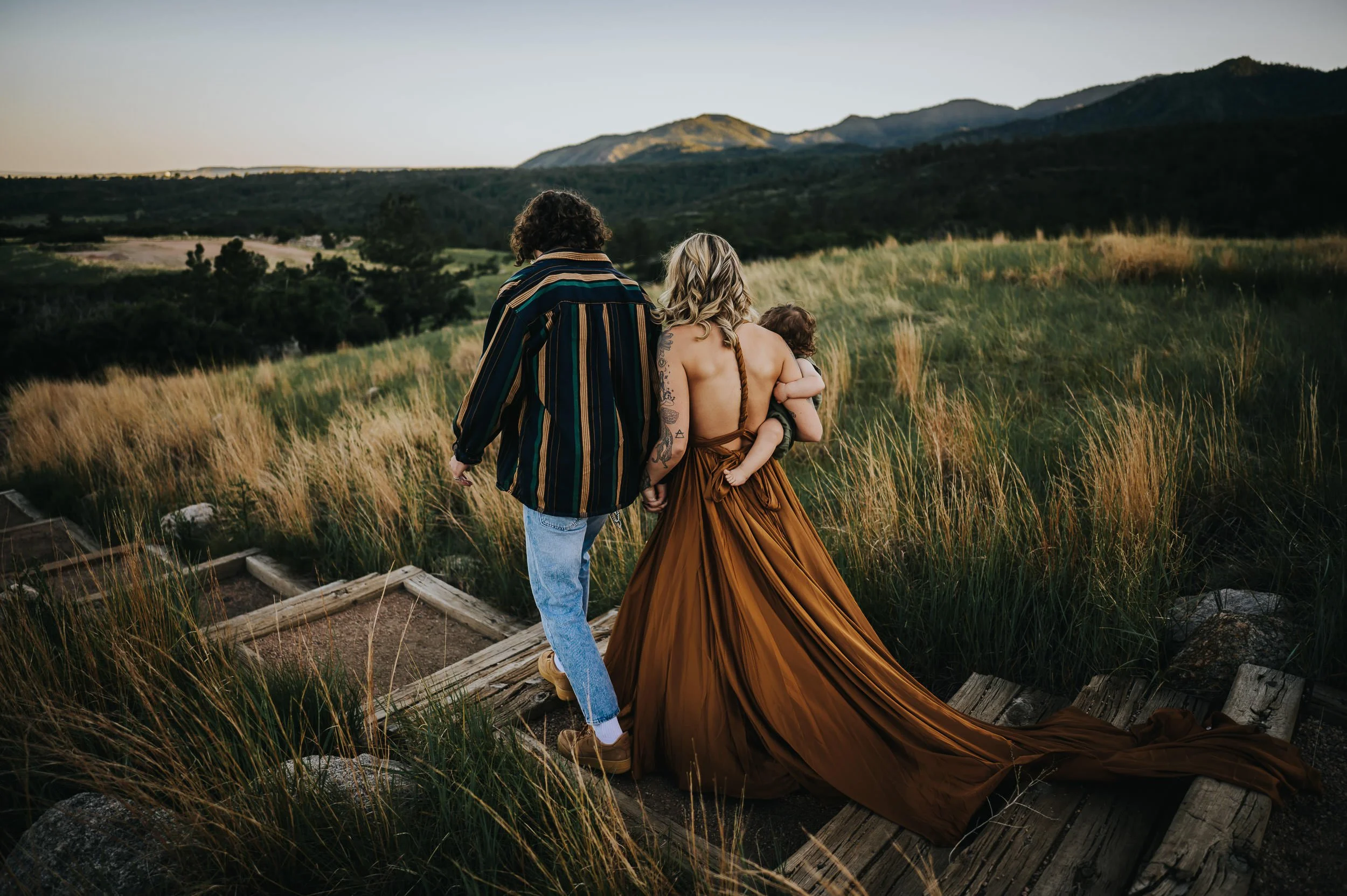 Movement-filled family photography session with parents and young child in Colorado Springs