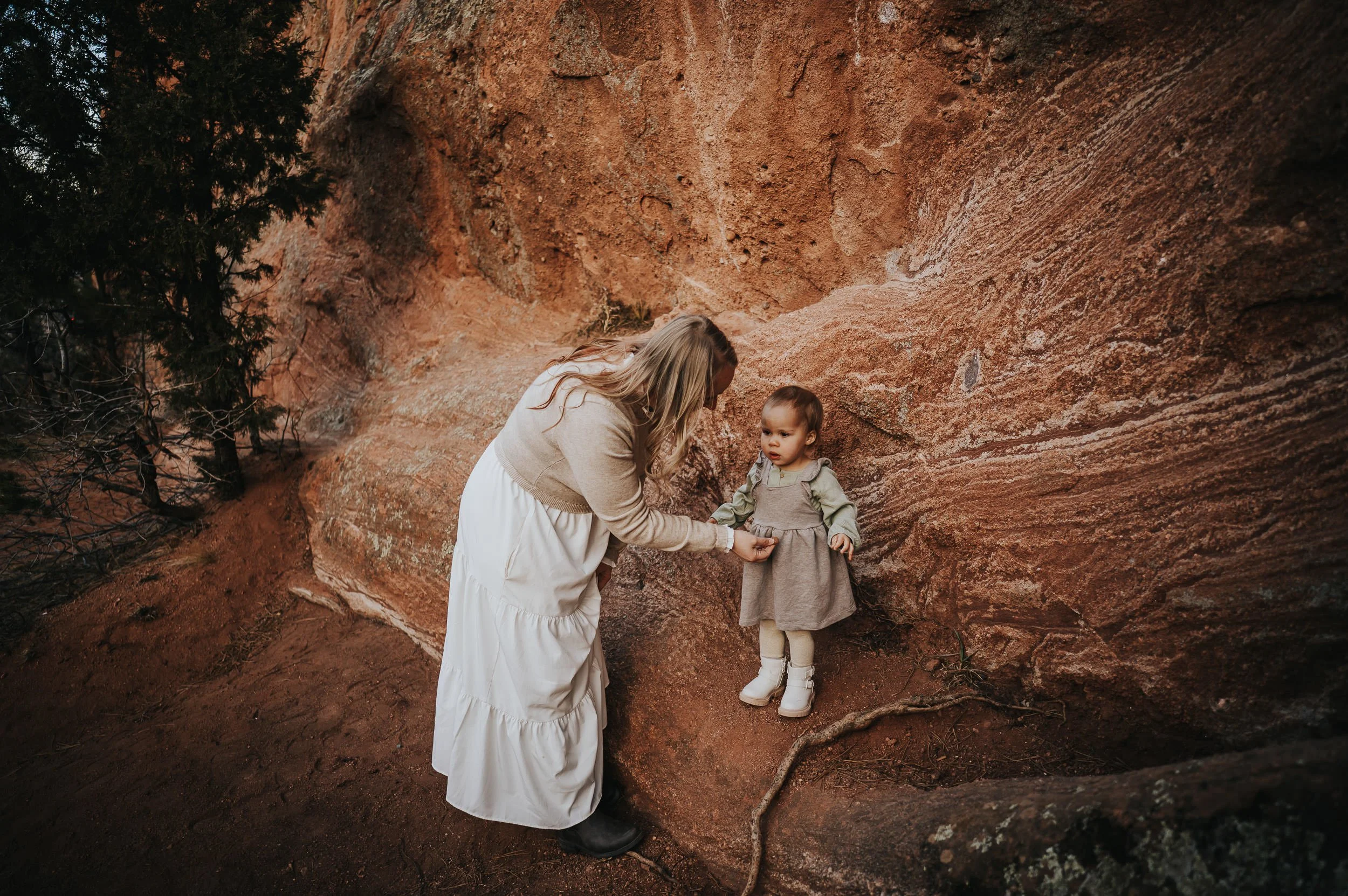 Parents comforting and laughing with their toddler during a relaxed family session in Colorado Springs.