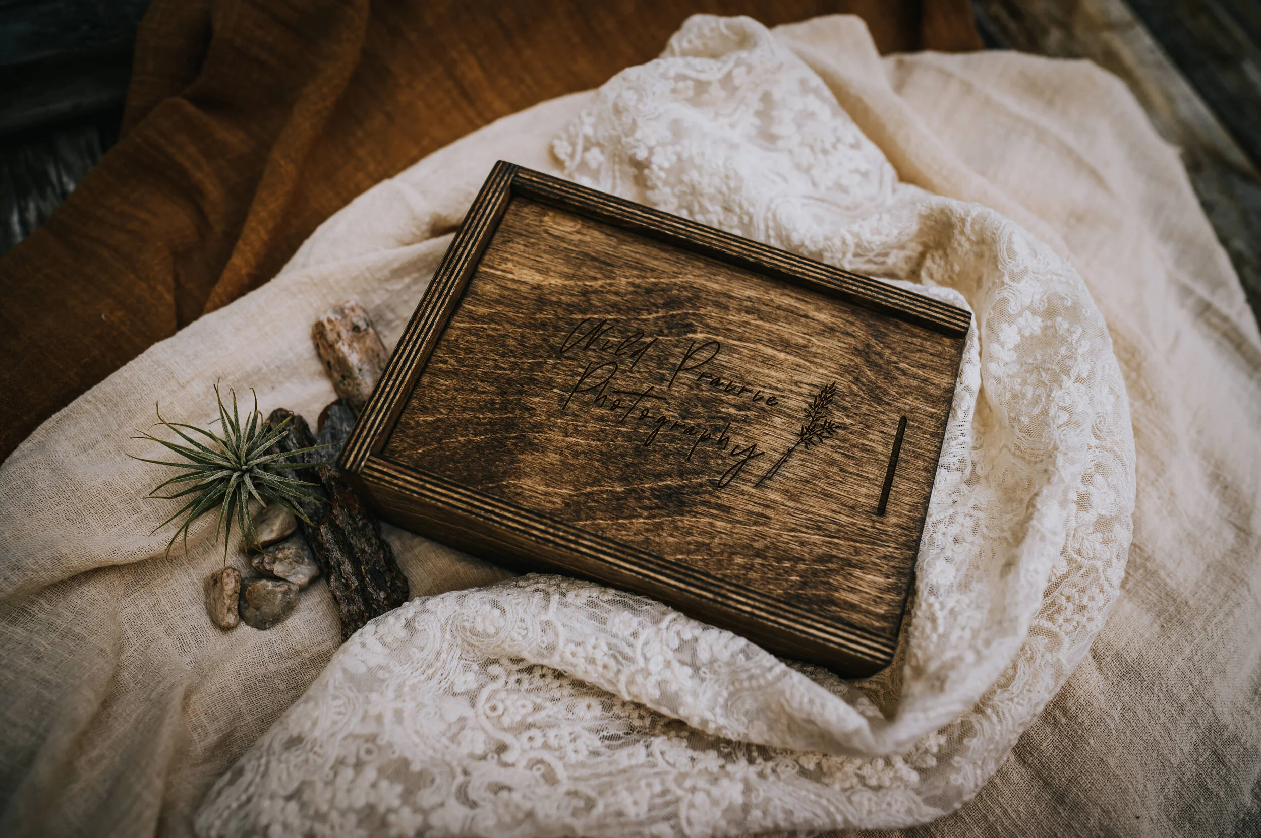 Closed wooden keepsake box resting on linen fabric.