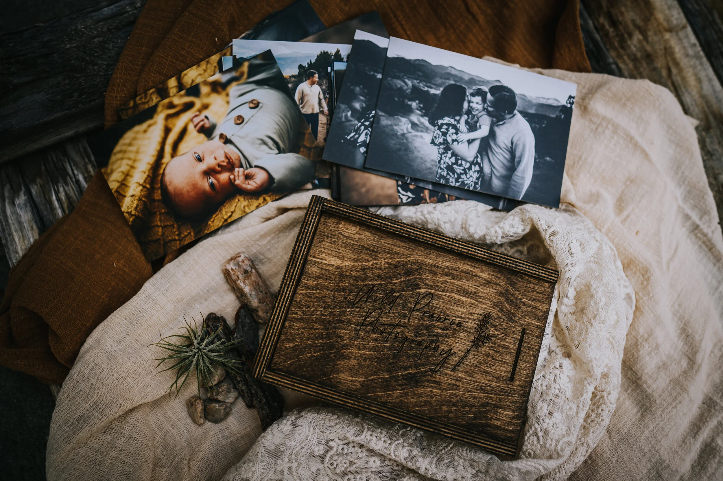 Curated prints and a wooden keepsake box on linen fabric.