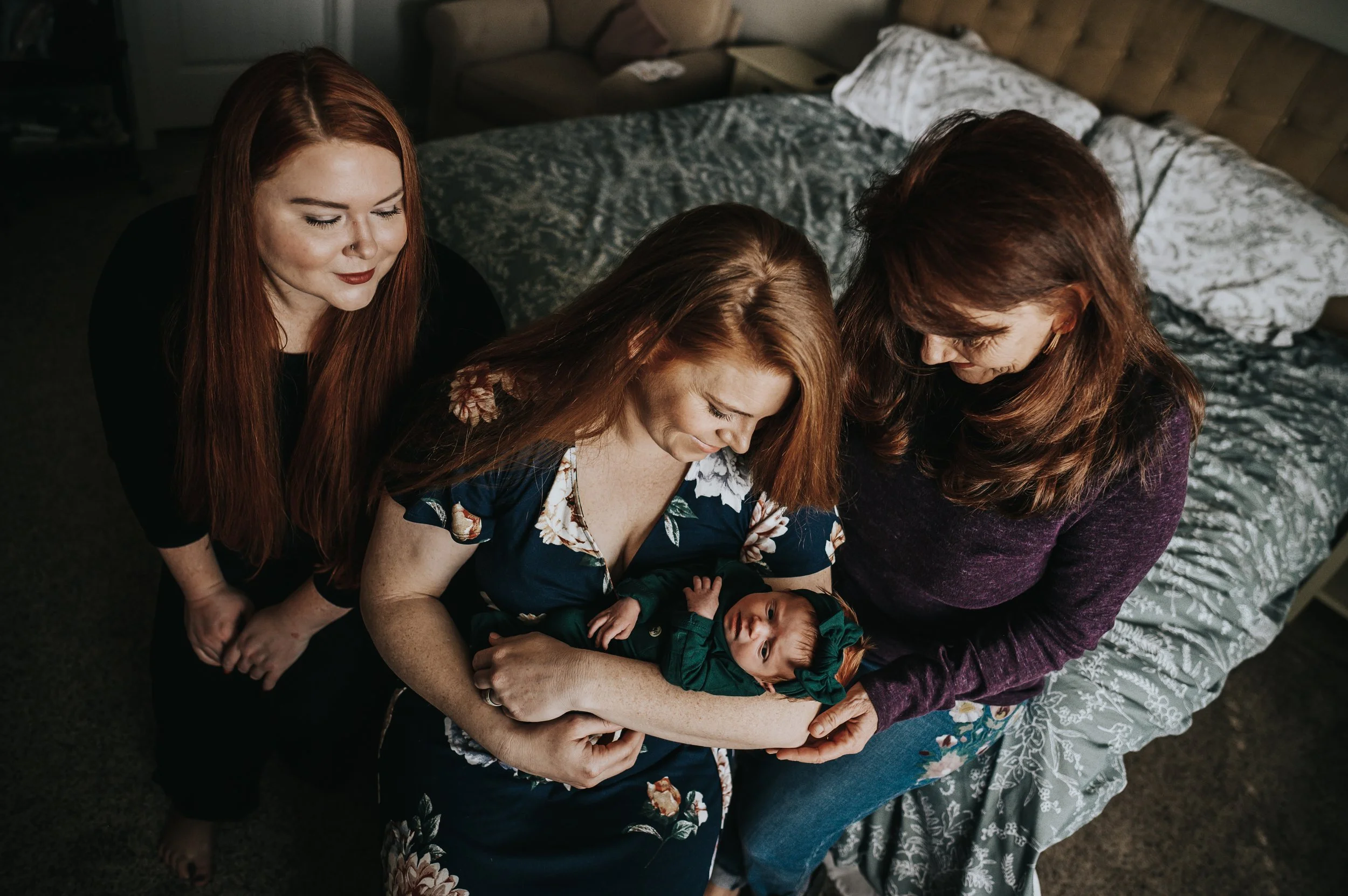 Grandmother holding newborn daughter during lifestyle newborn session in Colorado Springs.
