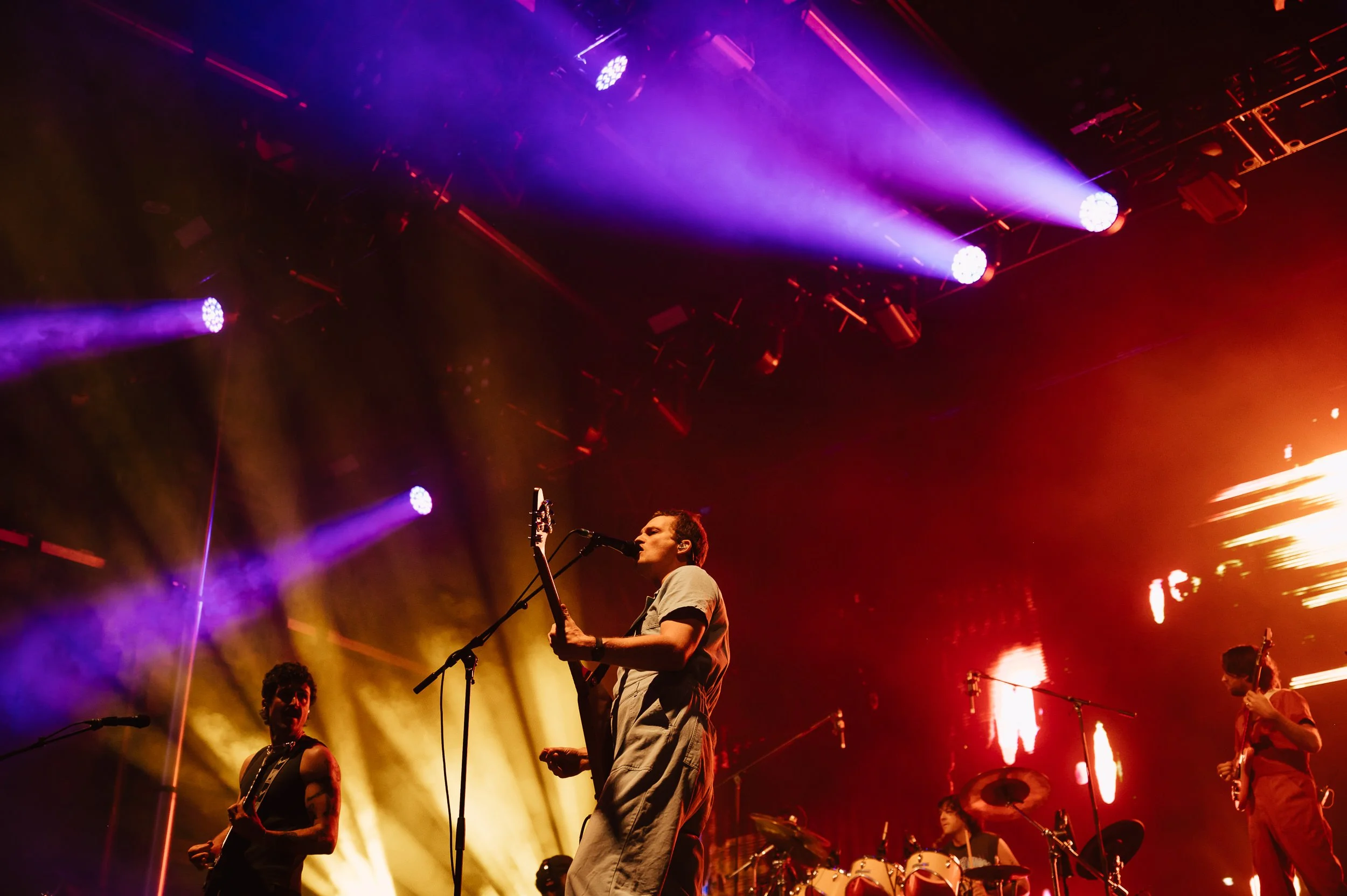 King Gizzard performing with dramatic red and orange stage lighting.