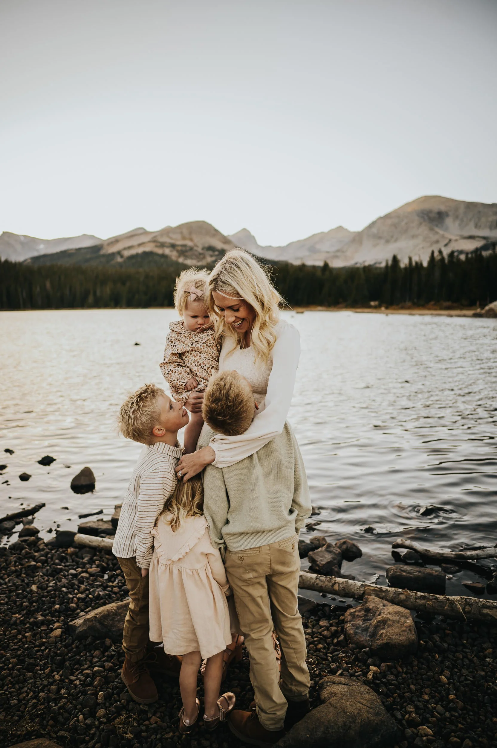 Family walking along the shore of Brainard Lake with the Indian Peaks Wilderness in the background.