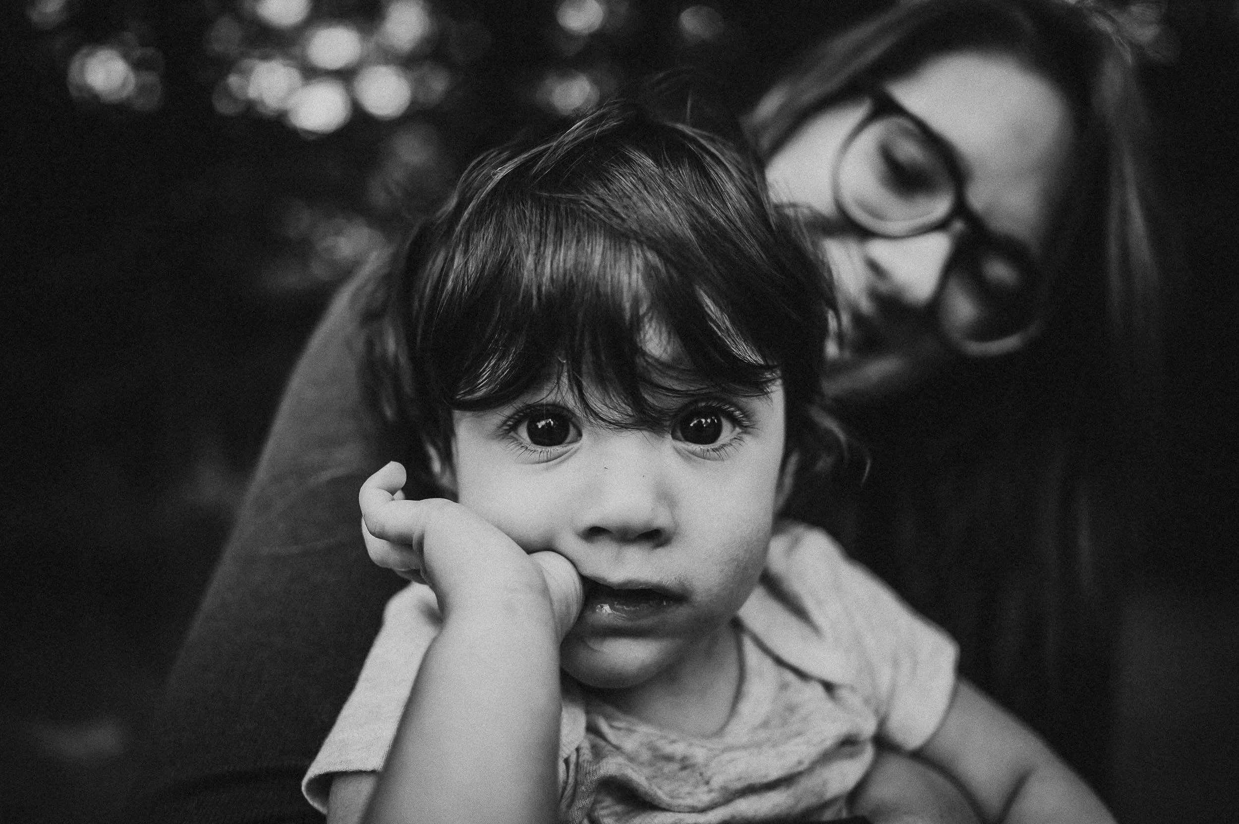 toddler-biting-finger-bokeh-bw.jpg