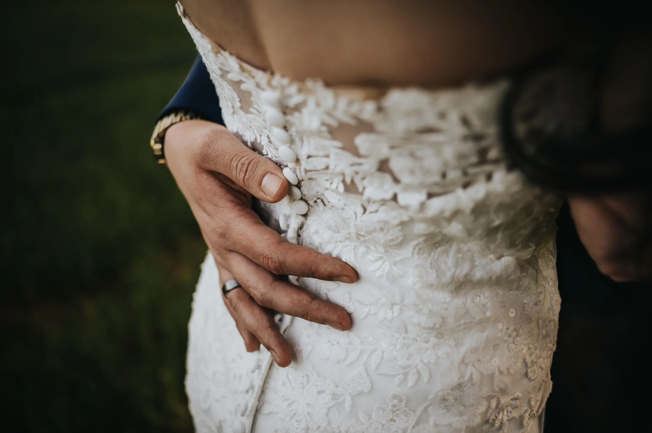 Wedding ring and dress details at Younger Ranch mountain ranch venue in Colorado.