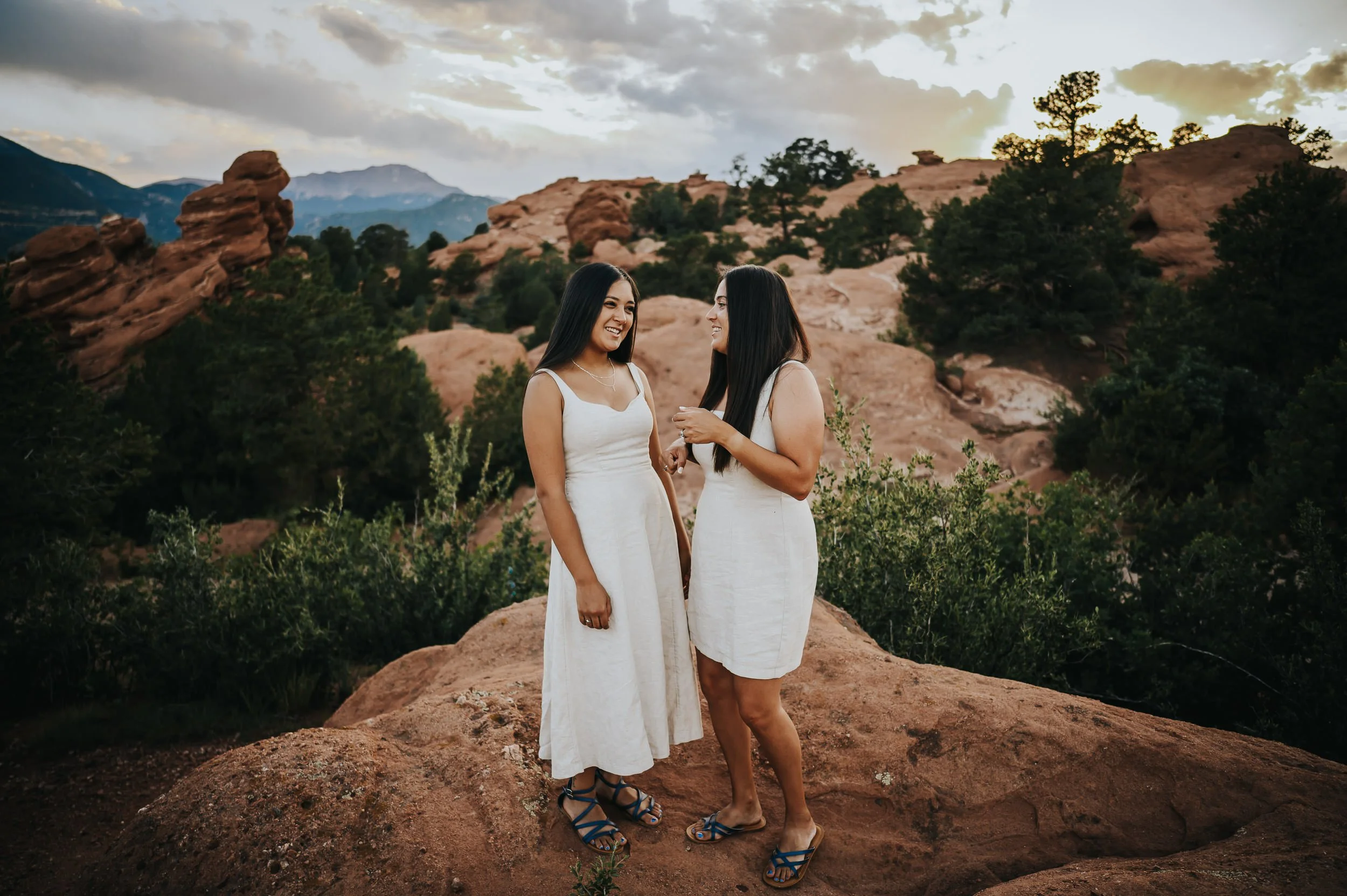 Mother and daughter sharing a quiet moment surrounded by red rock light at Garden of the Gods.